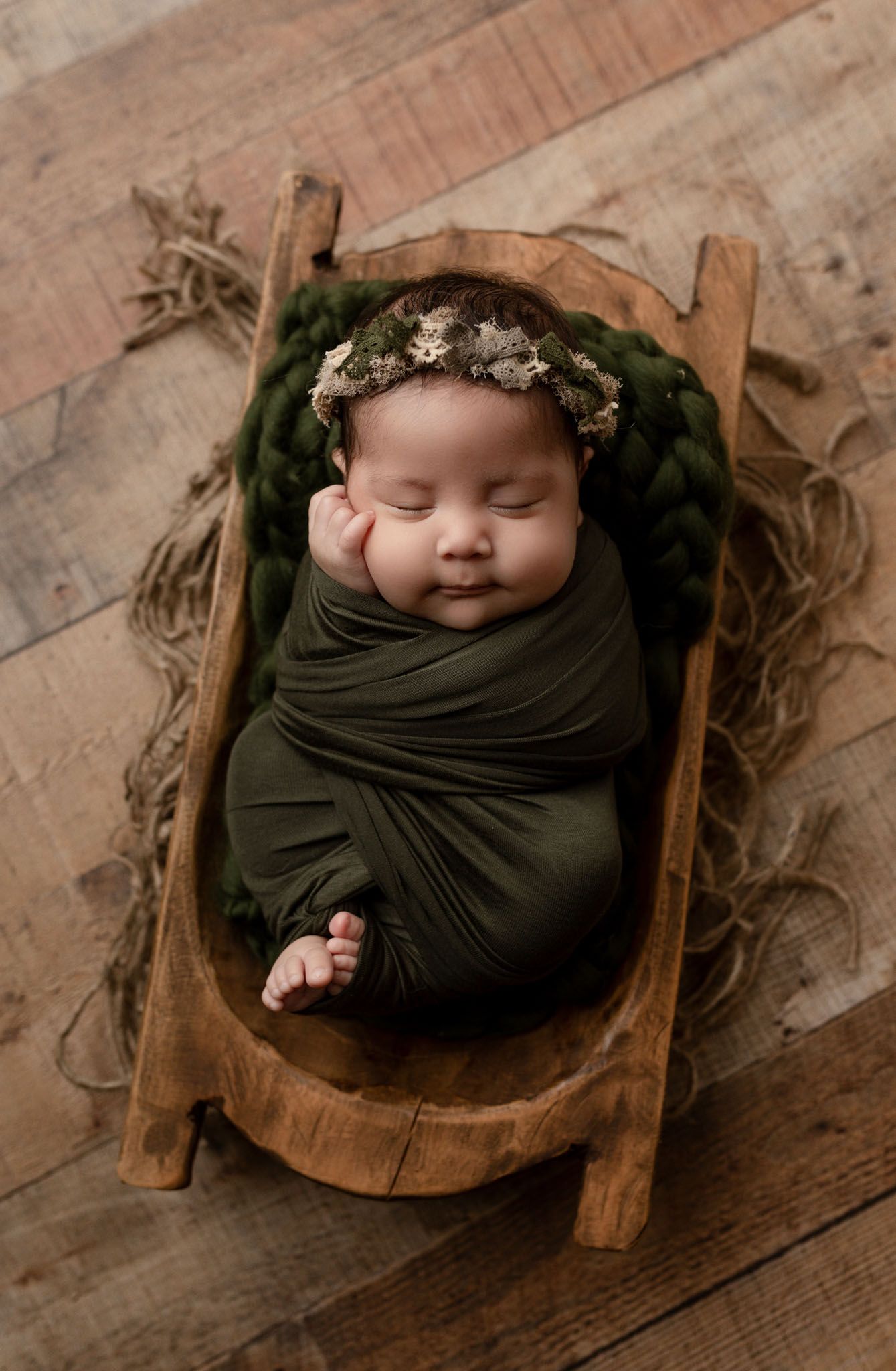 Eden Prairie newborn photographer | Newborn baby wrapped in green cloth with headband in wooden bowl on wood floor