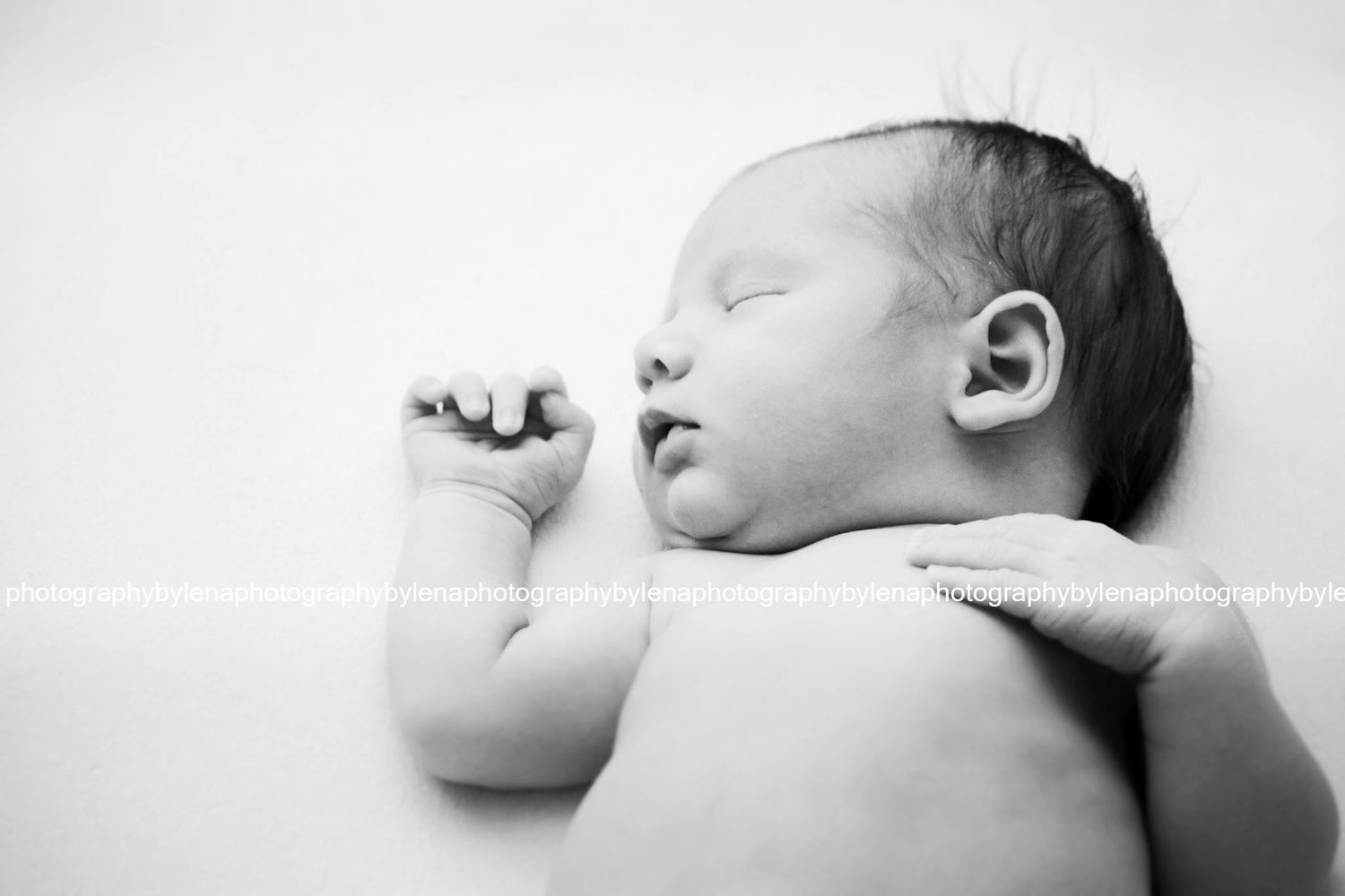 Artistic black and white profile view of sleeping infant.