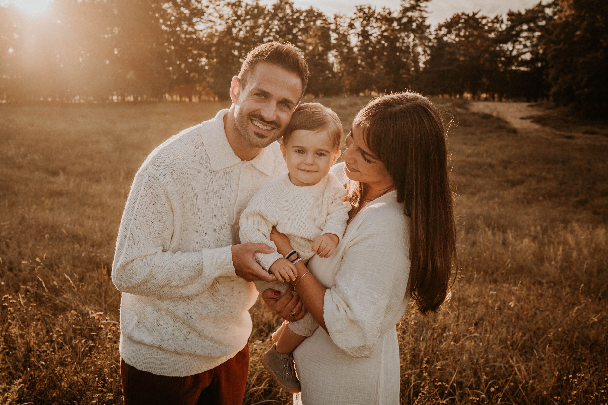 Sepia-toned outdoor family photography session at golden hour.