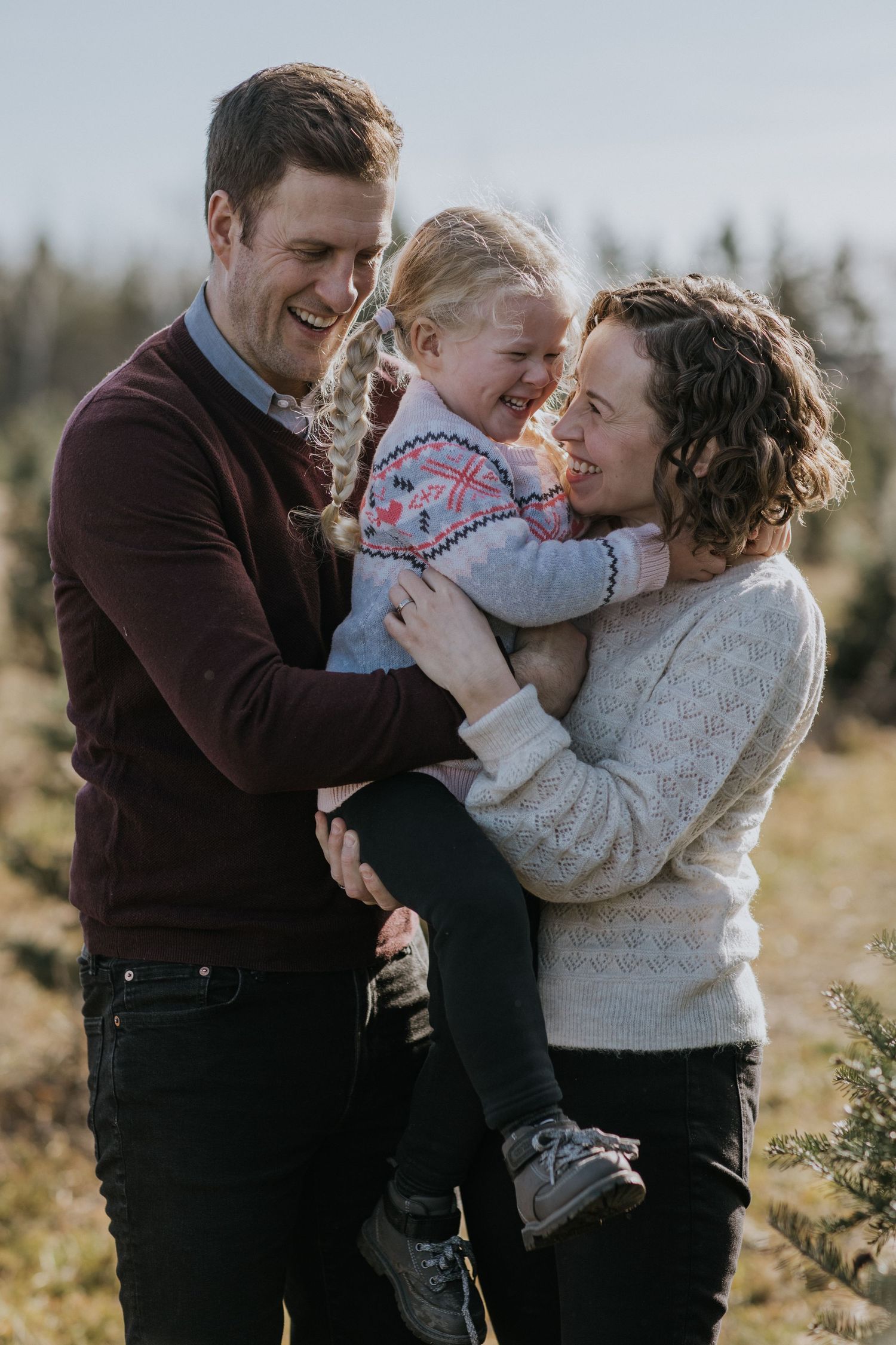 Candid winter family portraits showing genuine laughter and joy.