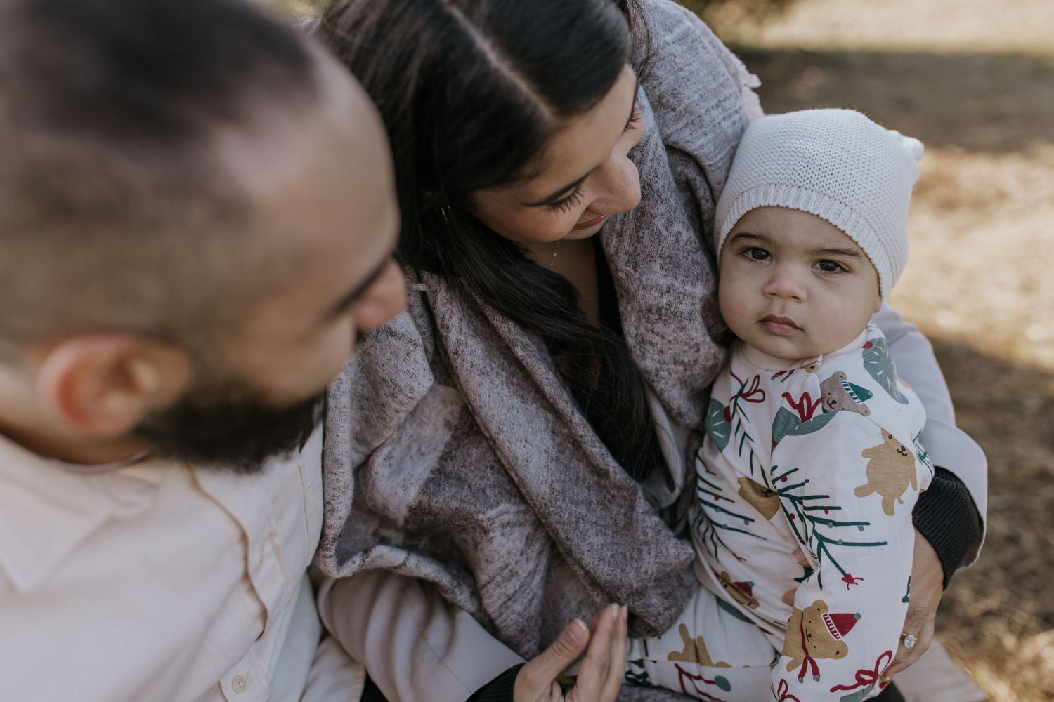 Intimate family moment captured outdoors with soft winter lighting.