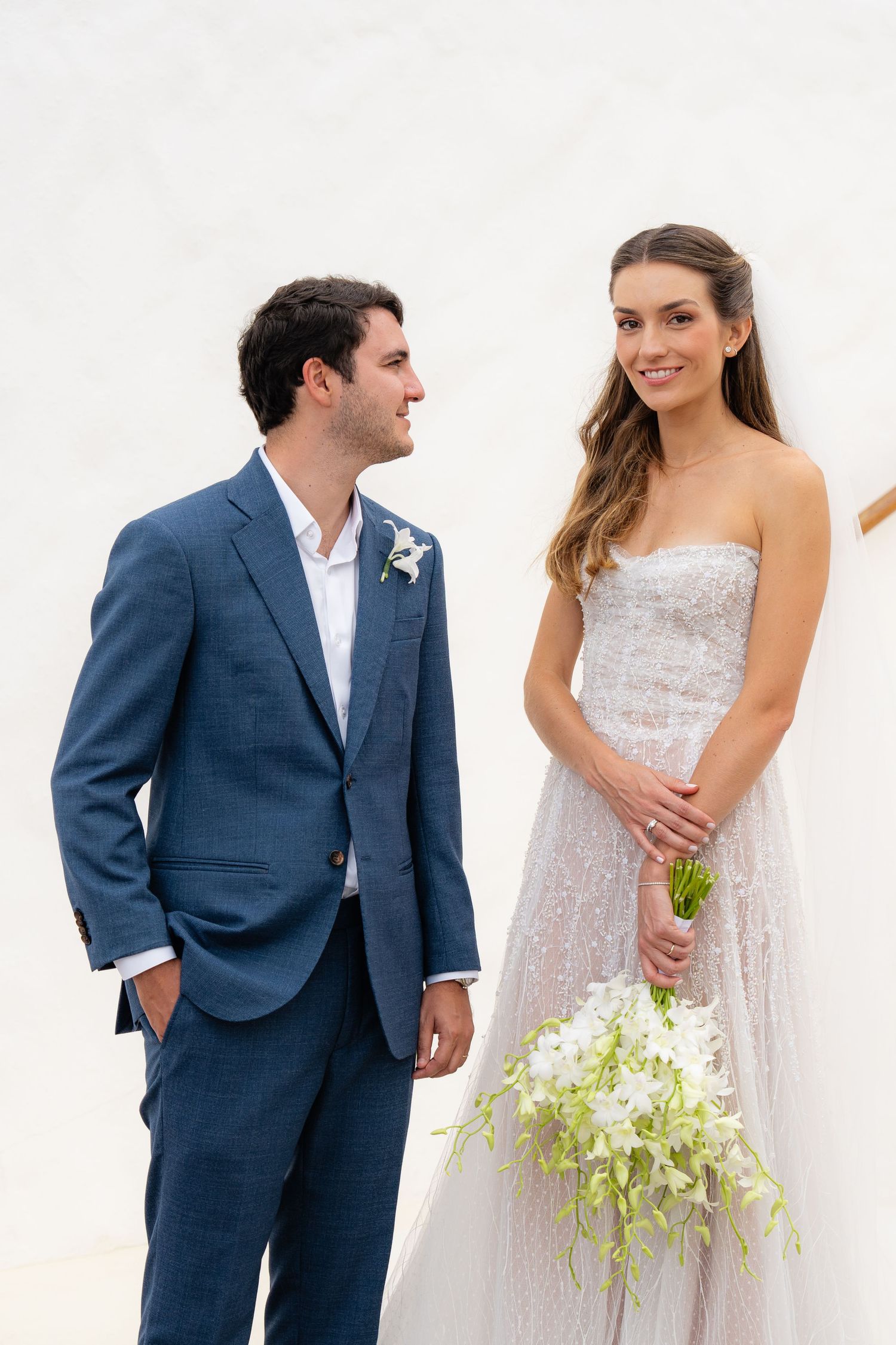 Candid wedding moments shared on a white Mediterranean staircase.