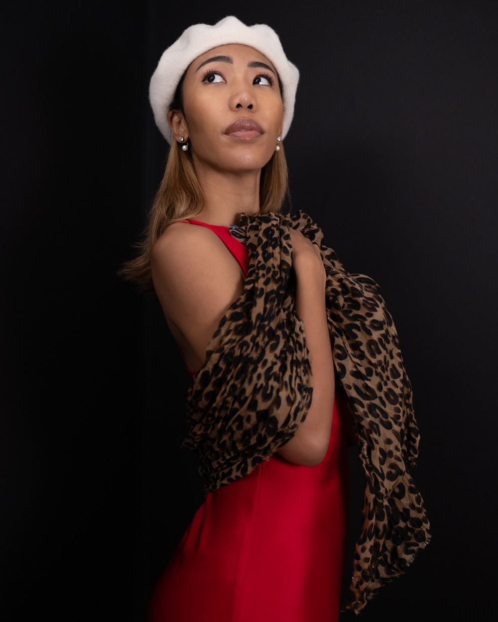 Woman in red dress and white hat, dramatic studio portrait, North Vancouver photographer