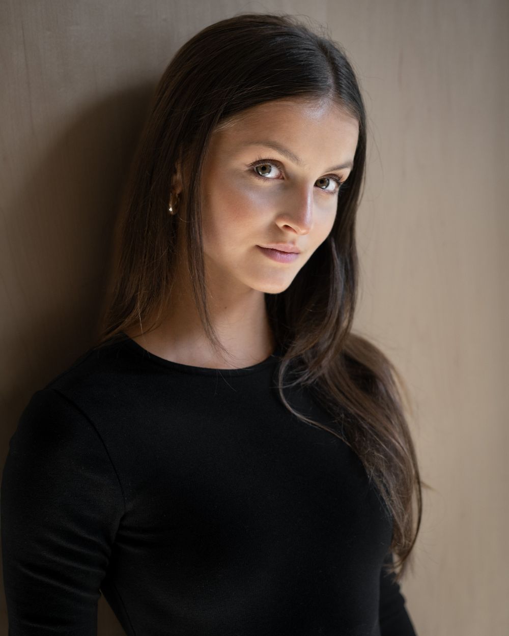 Woman in black top looking at camera, studio portrait session, North Vancouver photographer