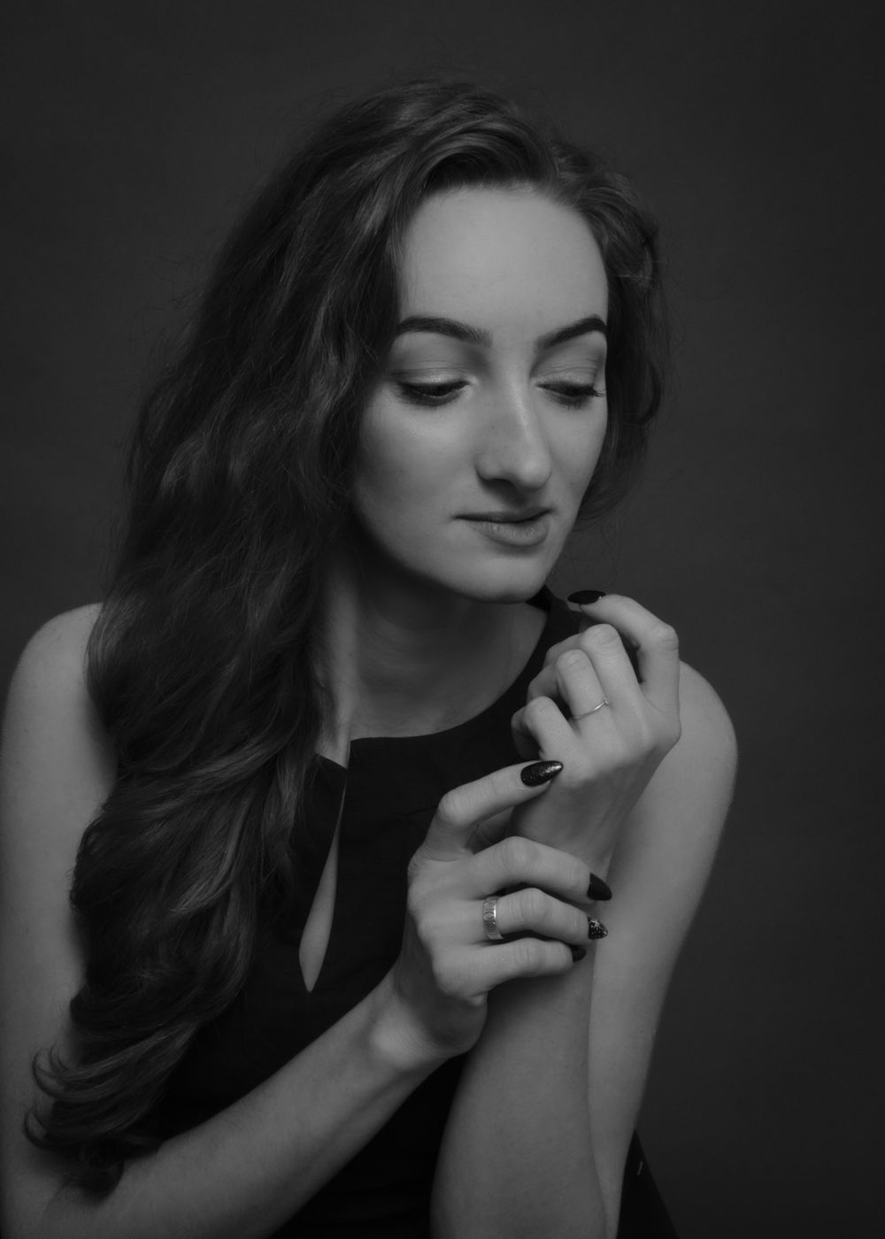 Black and white portrait of woman with hand near face, studio portrait, North Vancouver photographer