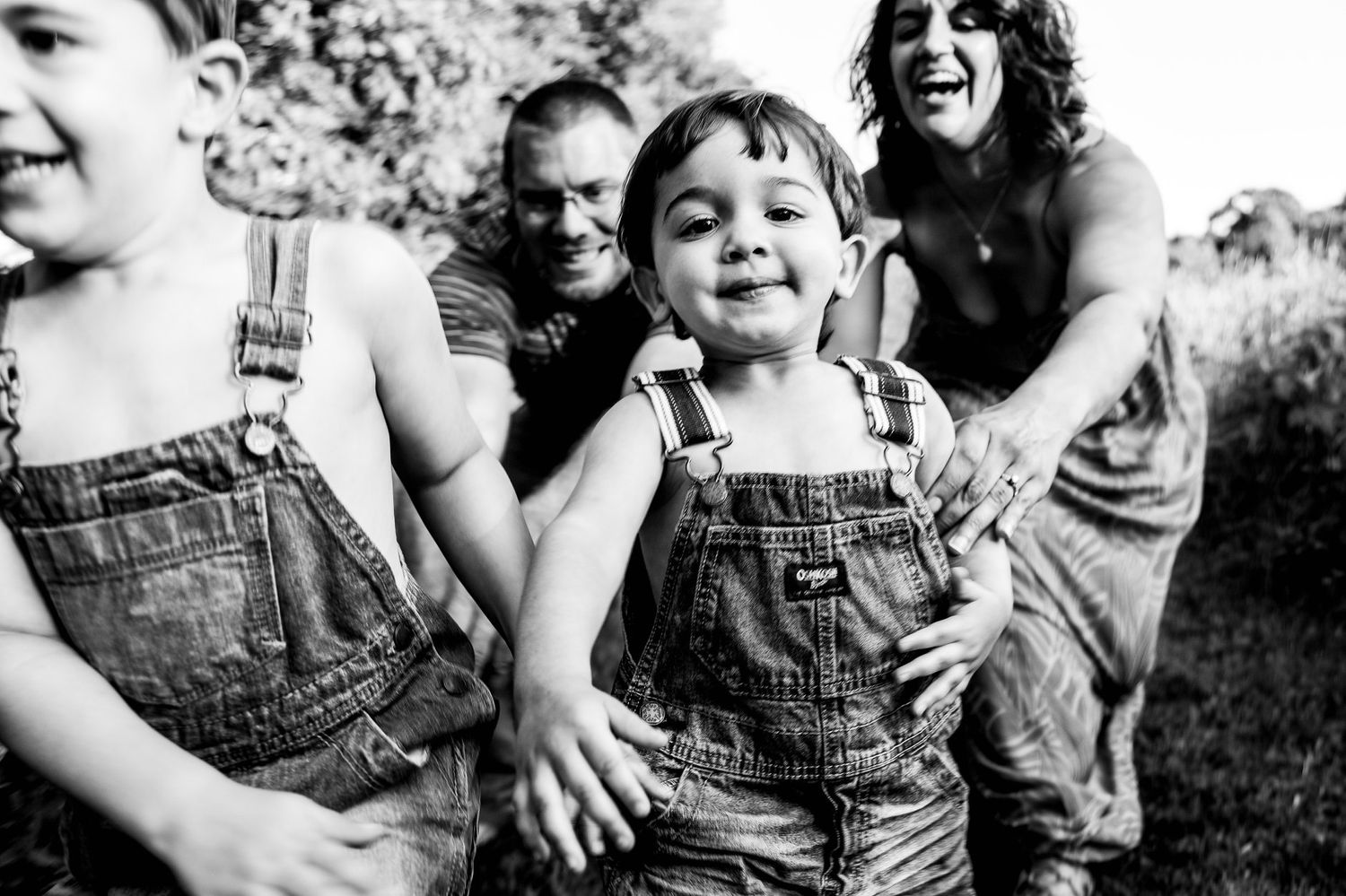 Series of joyful playful moments showing emotional expressions in black and white photography.