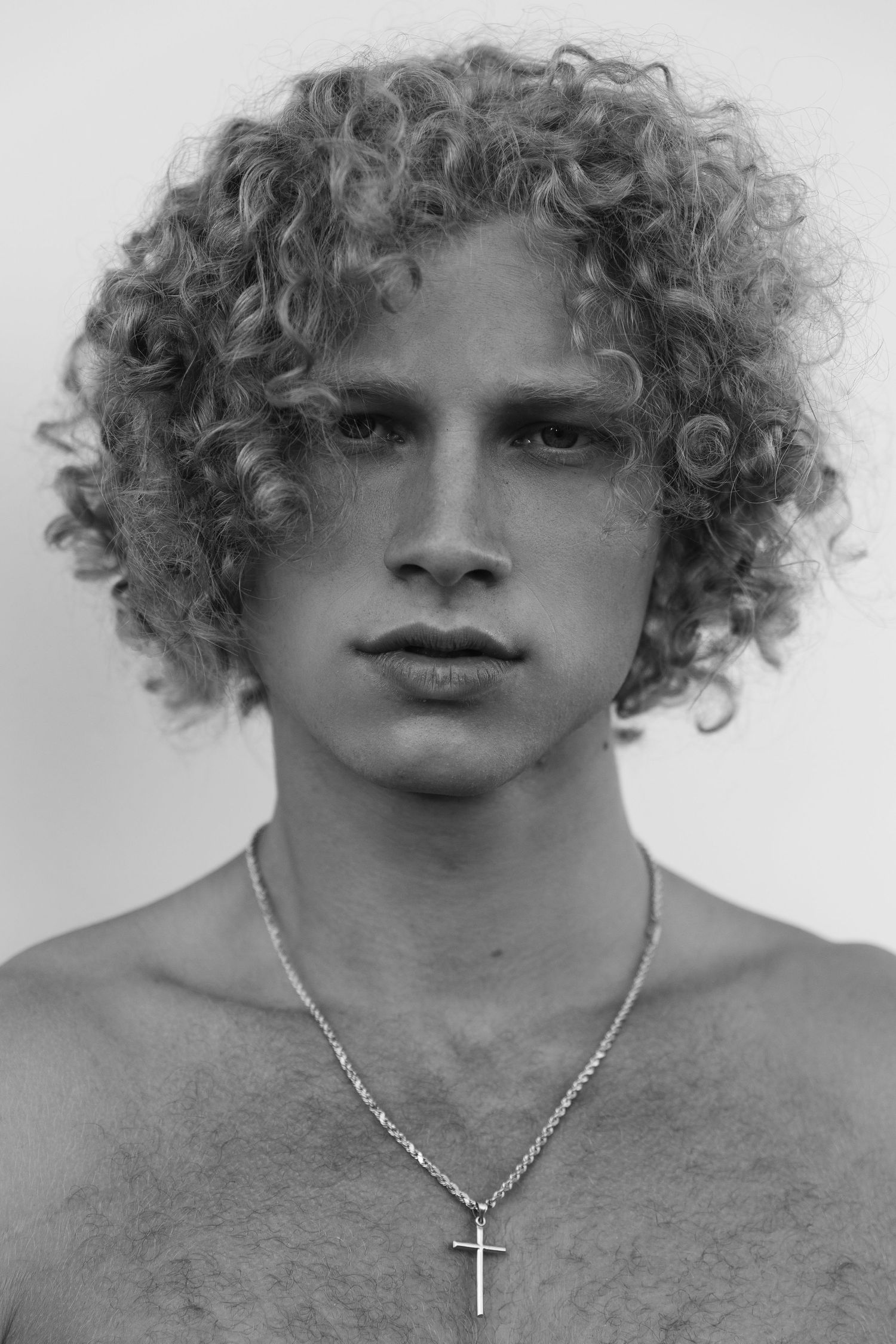 Black and white portrait of curly blonde male editorial model, San Clemente beach fashion editorial