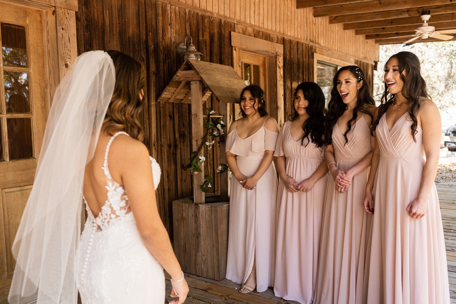 the first look from the bride with her girls at barn at crescent lake