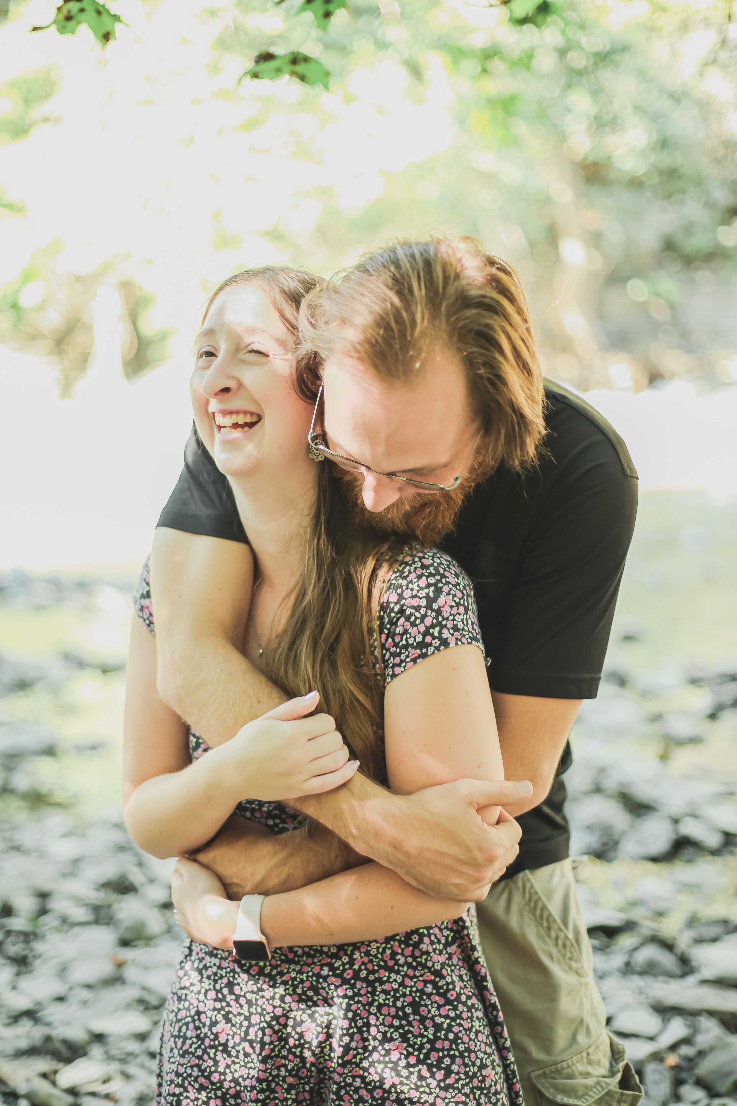 engagement photo hugging at ithaca falls in ithaca, ny
