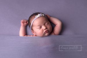newborn girl photography, lavender newborn swaddle, sleeping baby tucked in