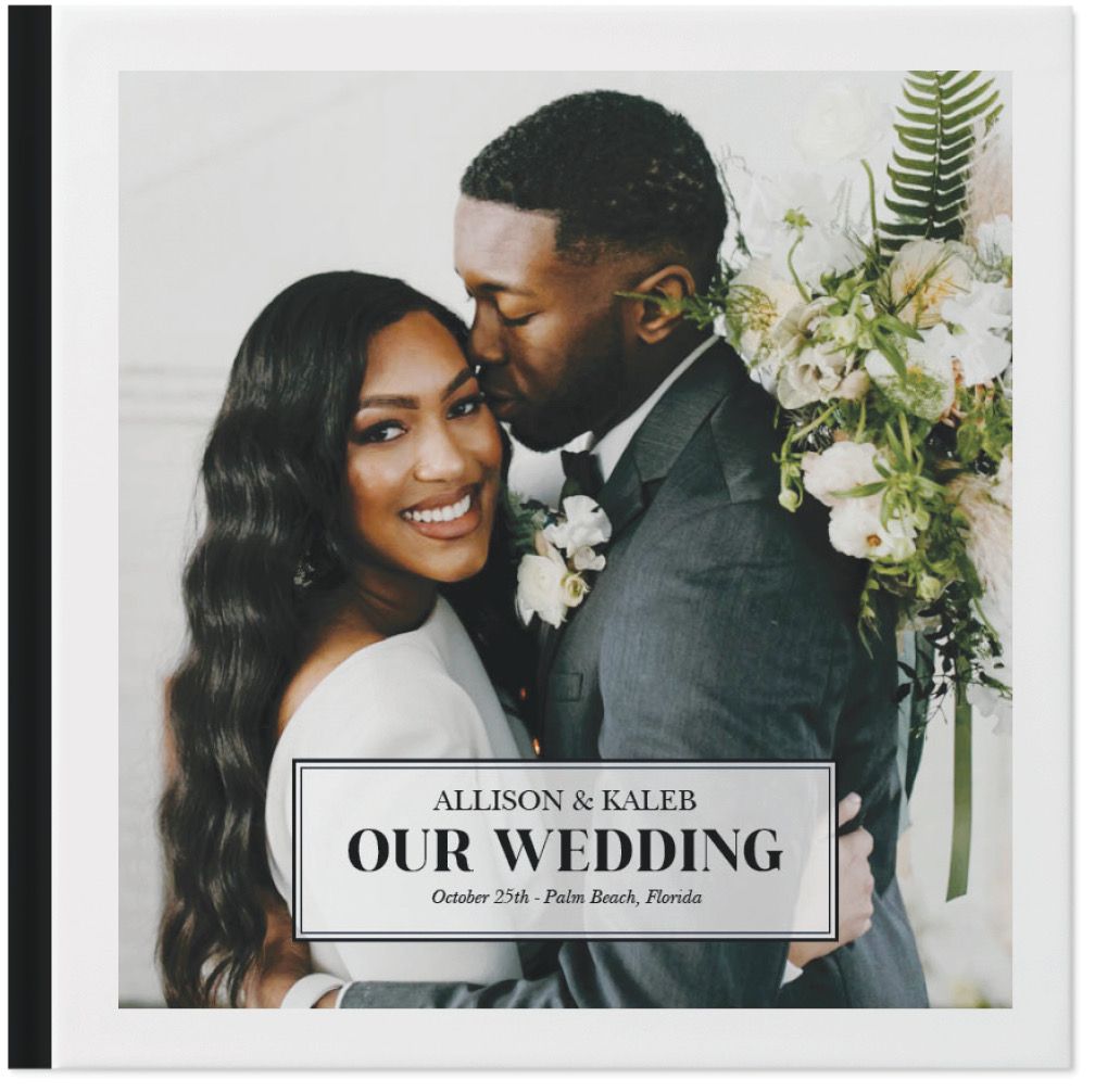 A wedding album cover featuring a professional black and white photo with floral decorations.