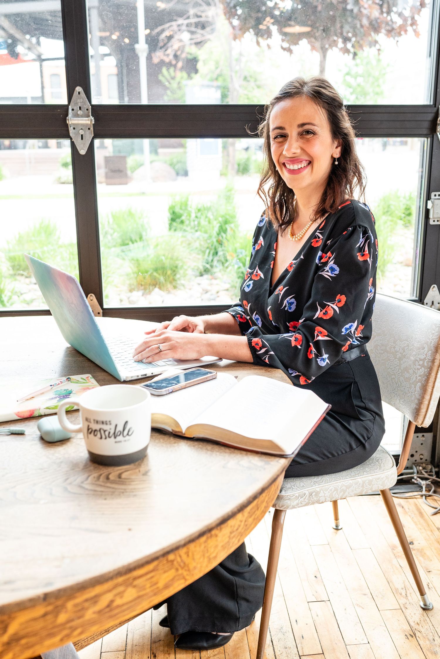 Jackie Morales smiling at camera while working on laptop