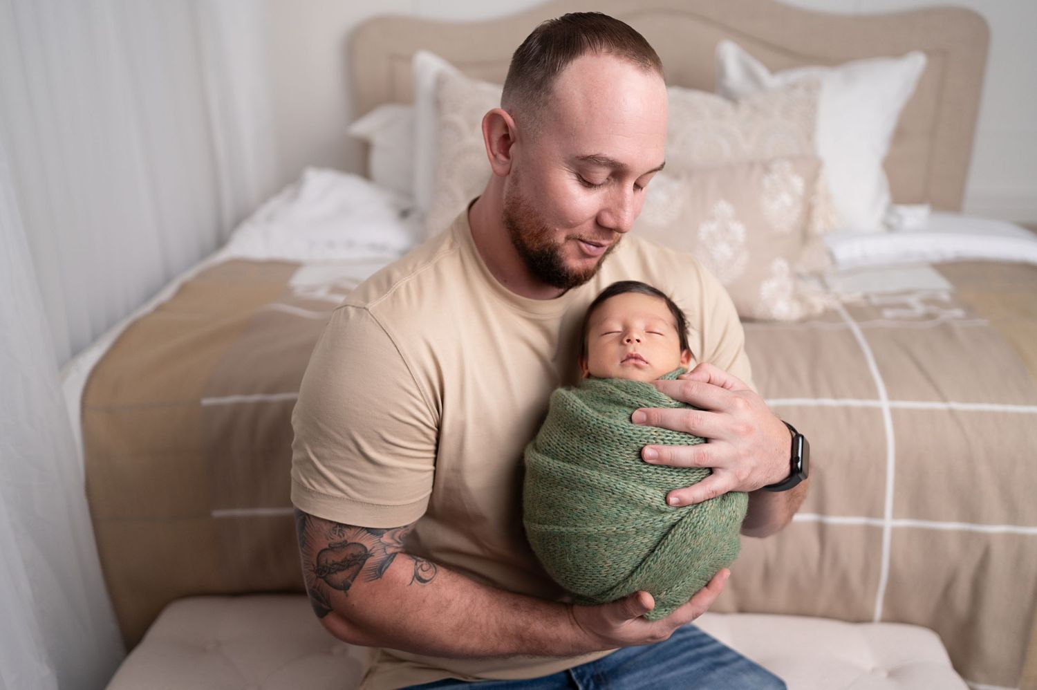 Cozy lifestyle newborn session on beige couch captures intimate family moments.