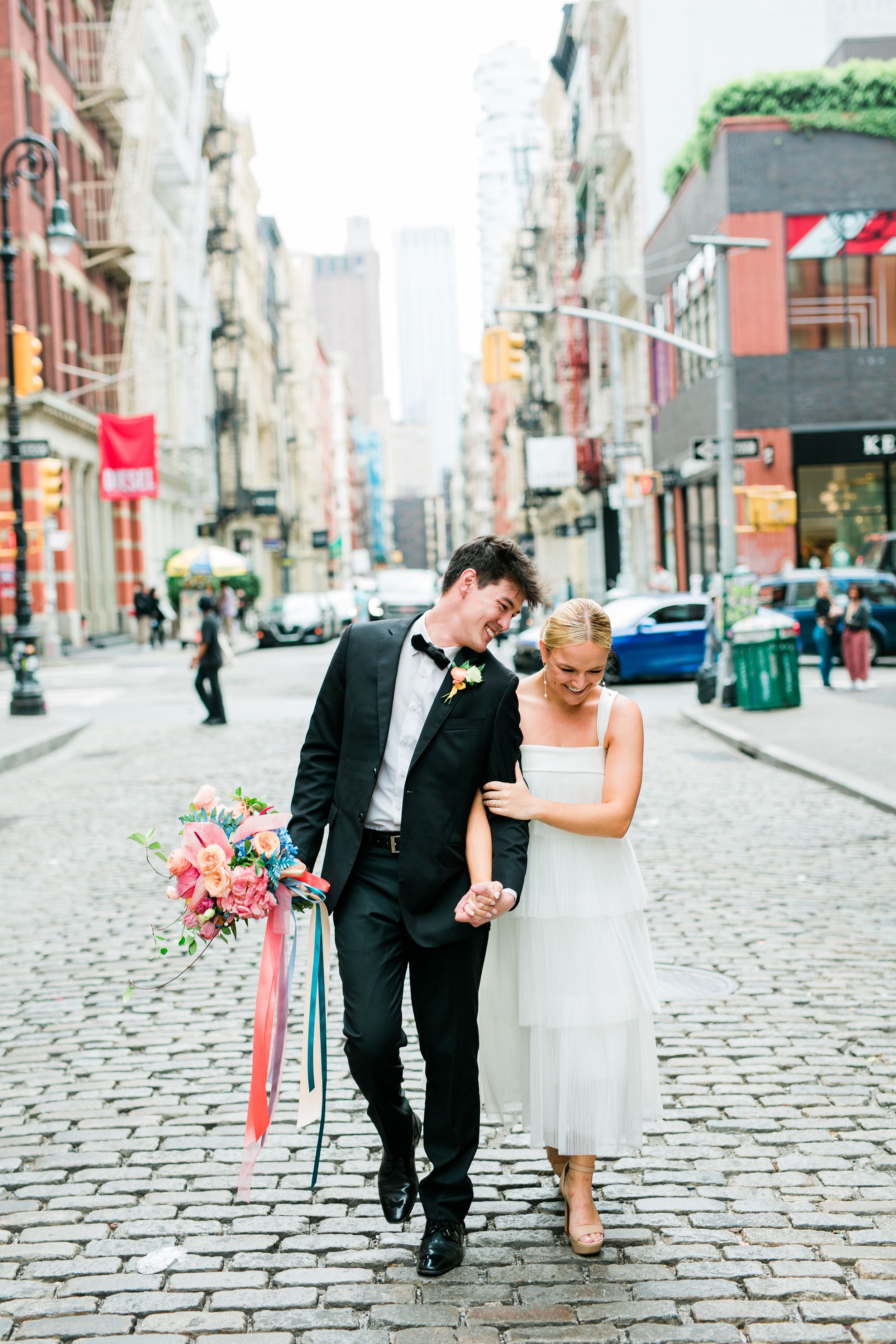 A romantic stroll down a cobblestone street with vintage buildings in the background.