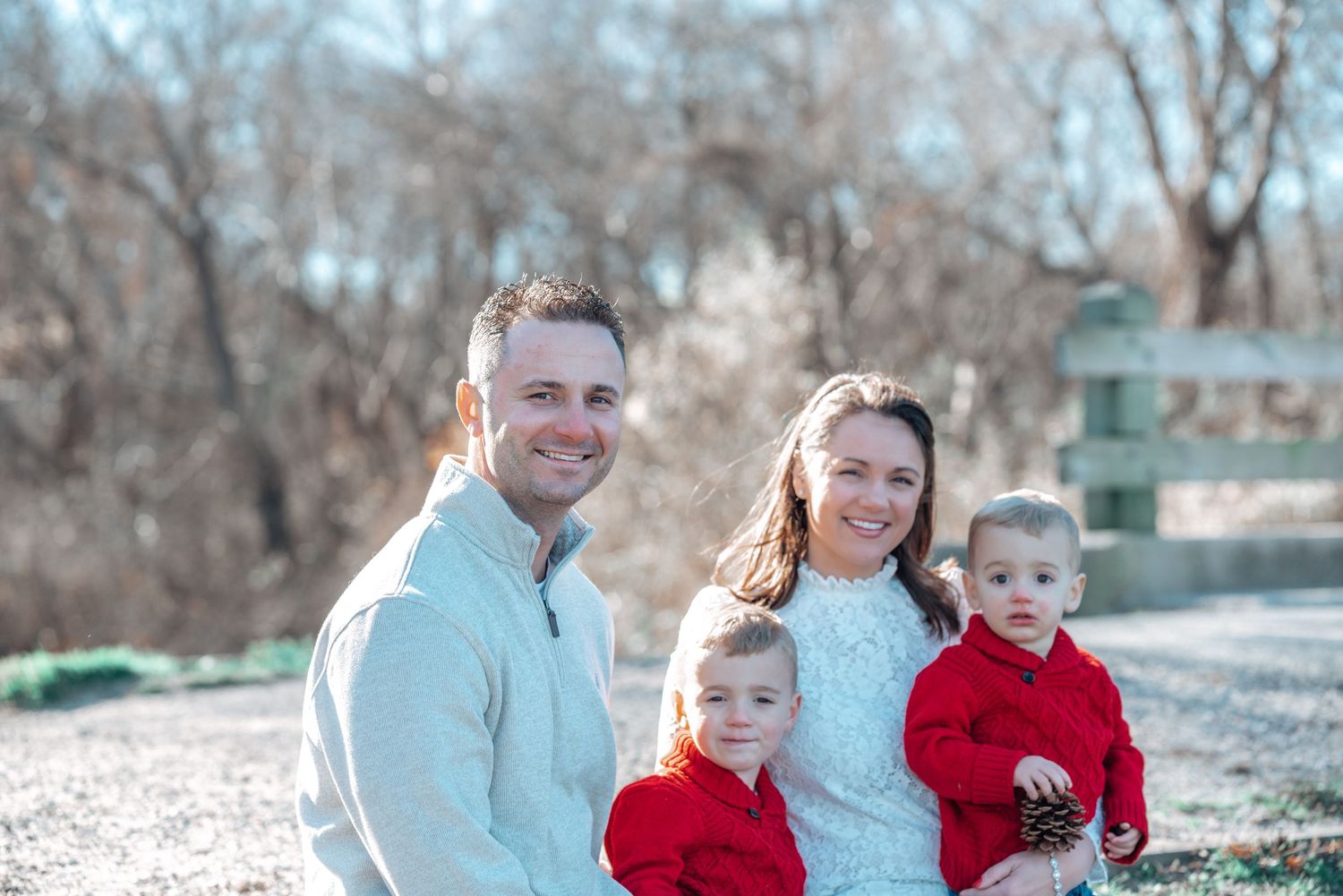 Family portrait taken outdoors on a bright winter day.