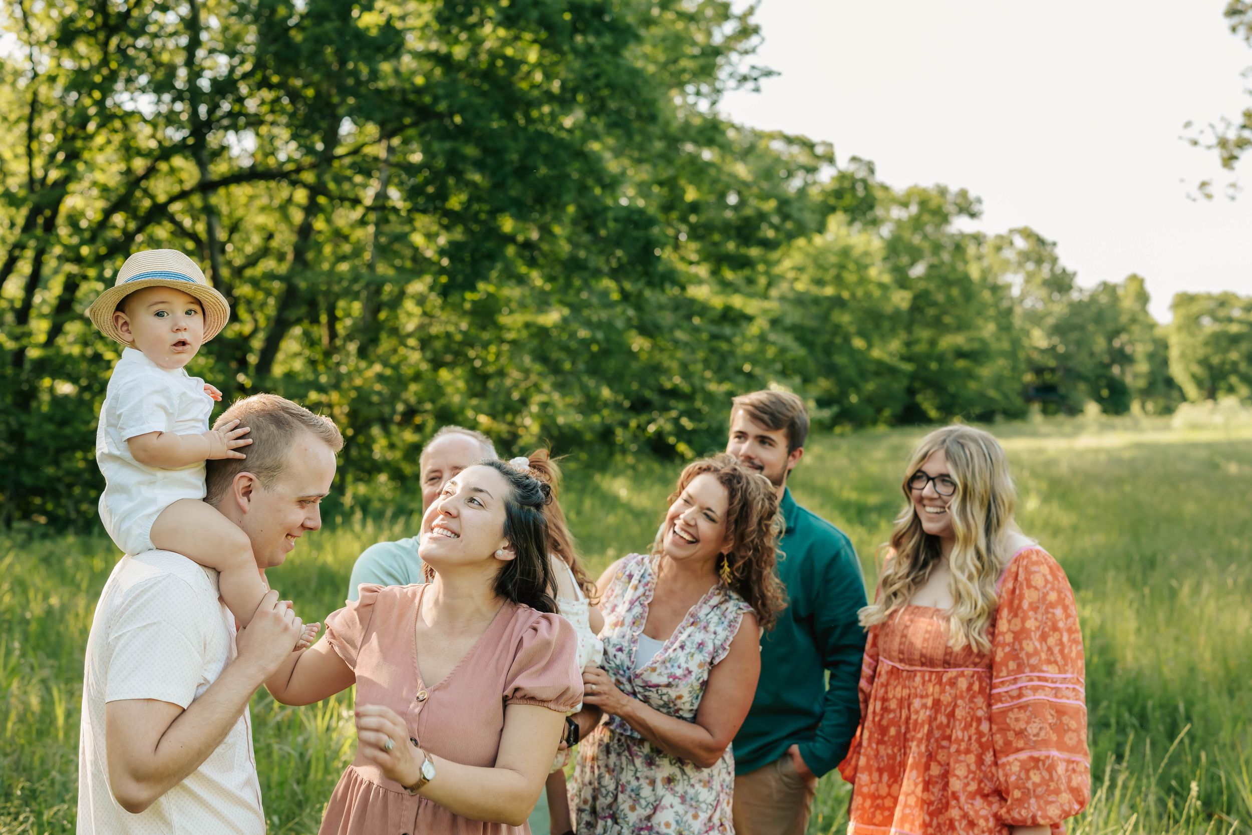 Group enjoying sunny day together in green summer field.