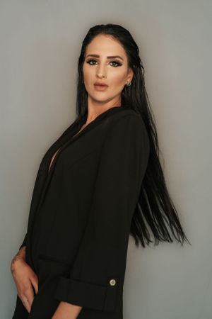 Fashion series featuring model in black clothing against neutral background.