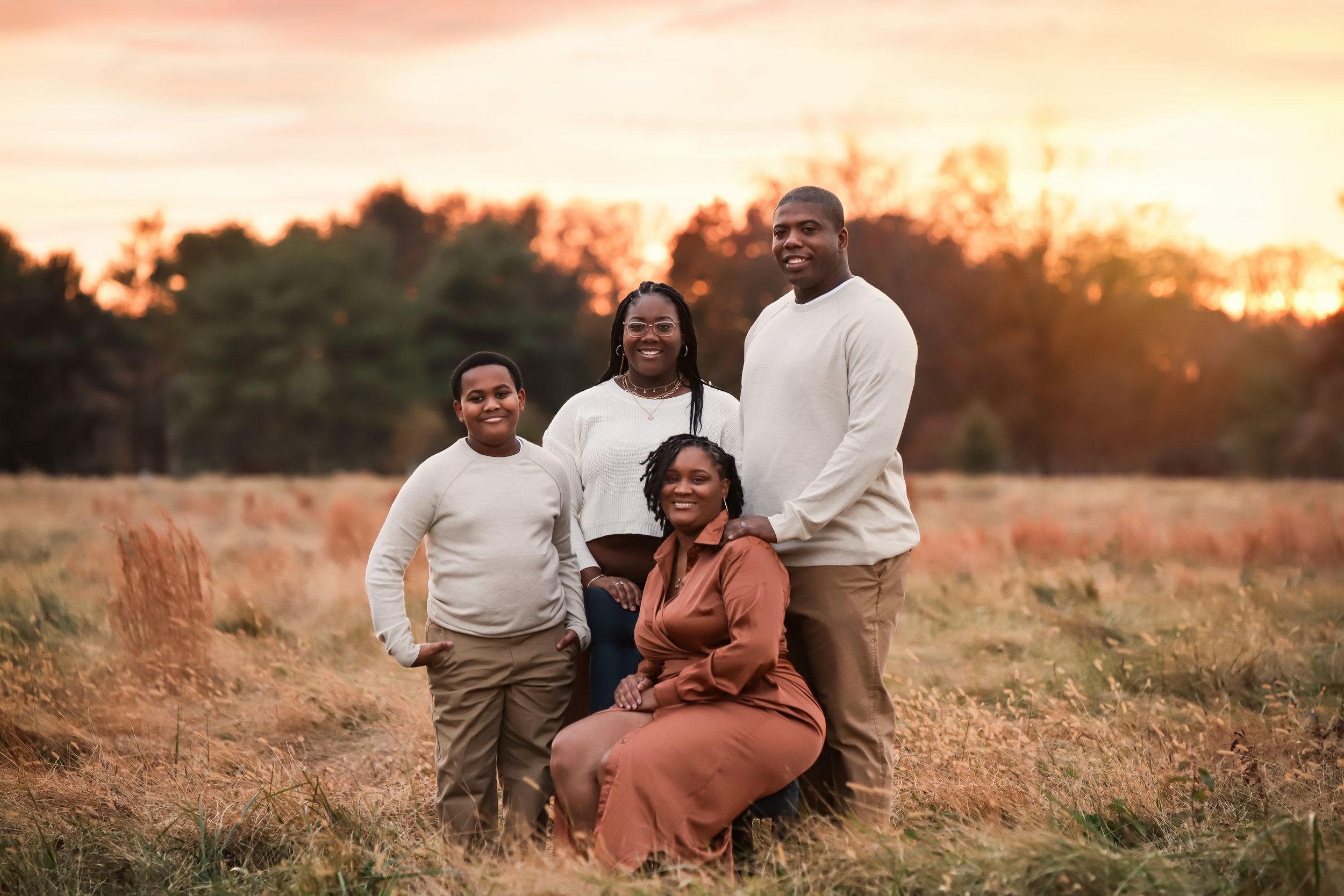 fine art family outdoor portrait in a field during sunset in the summer