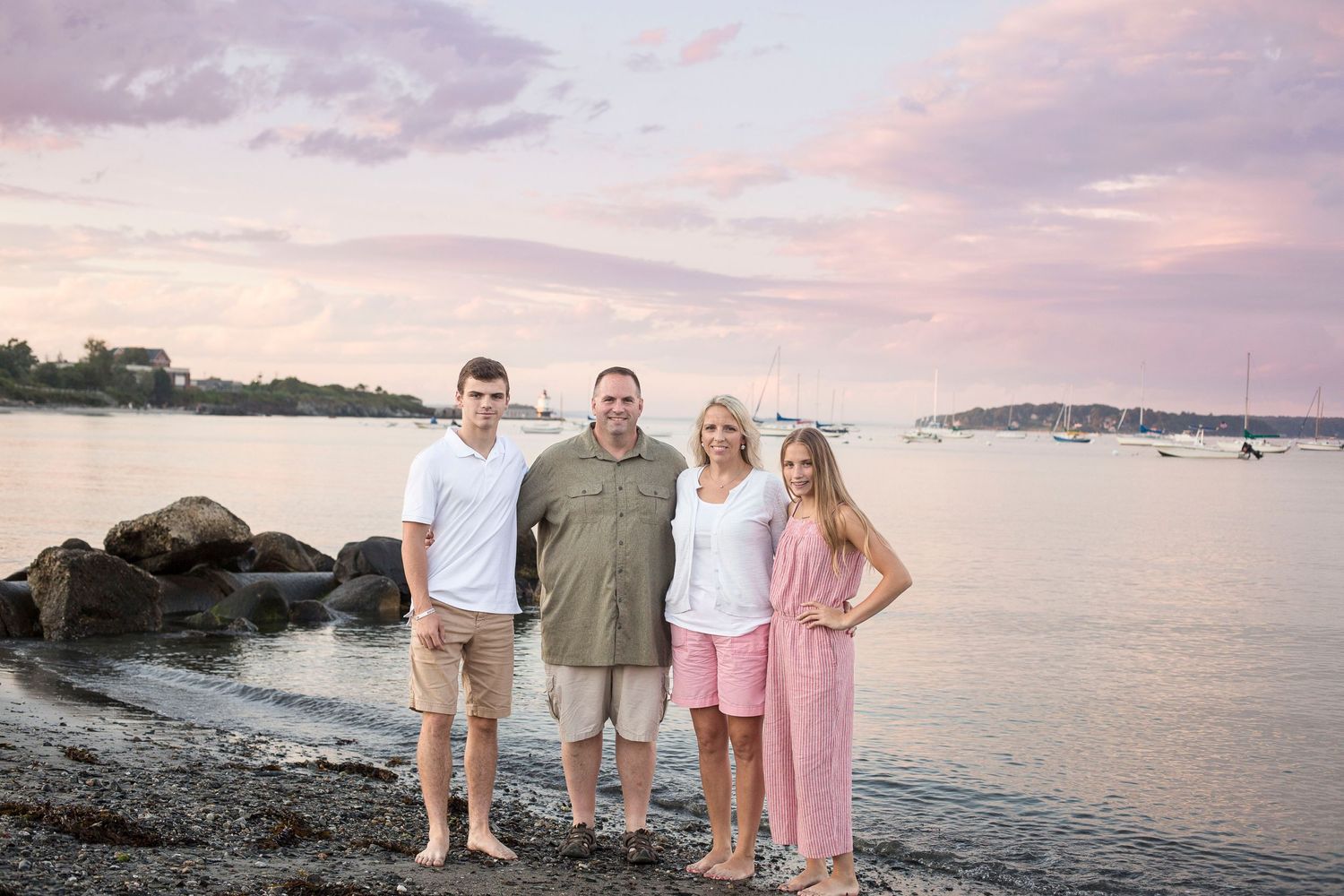 A family standing on the beach in South Portland Maine