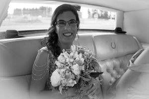 A beautiful moment captured in black and white showing a bouquet inside a classic car.