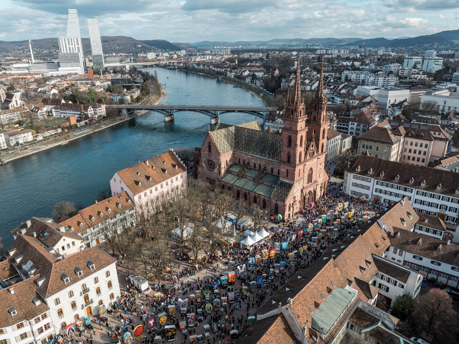 Aerial view of Basel city with Rhine River, bridges and historic cathedral.