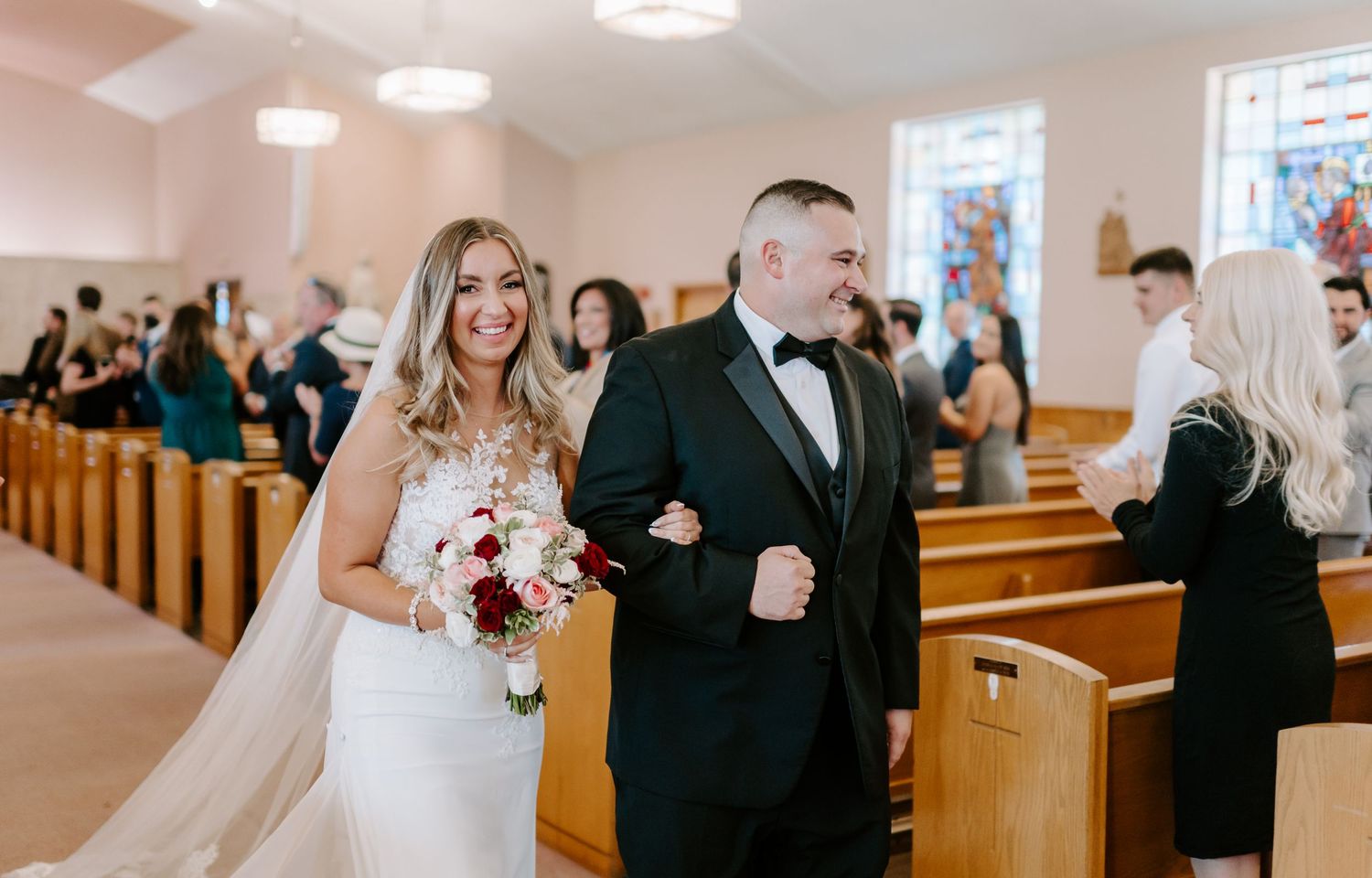 Wedding ceremony taking place in bright modern church interior.