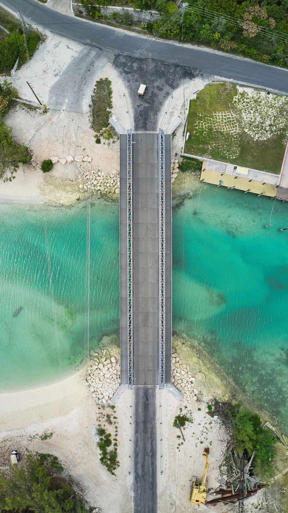 Aerial drone view of Spanish Wells Bridge spanning turquoise Bahamian waters.