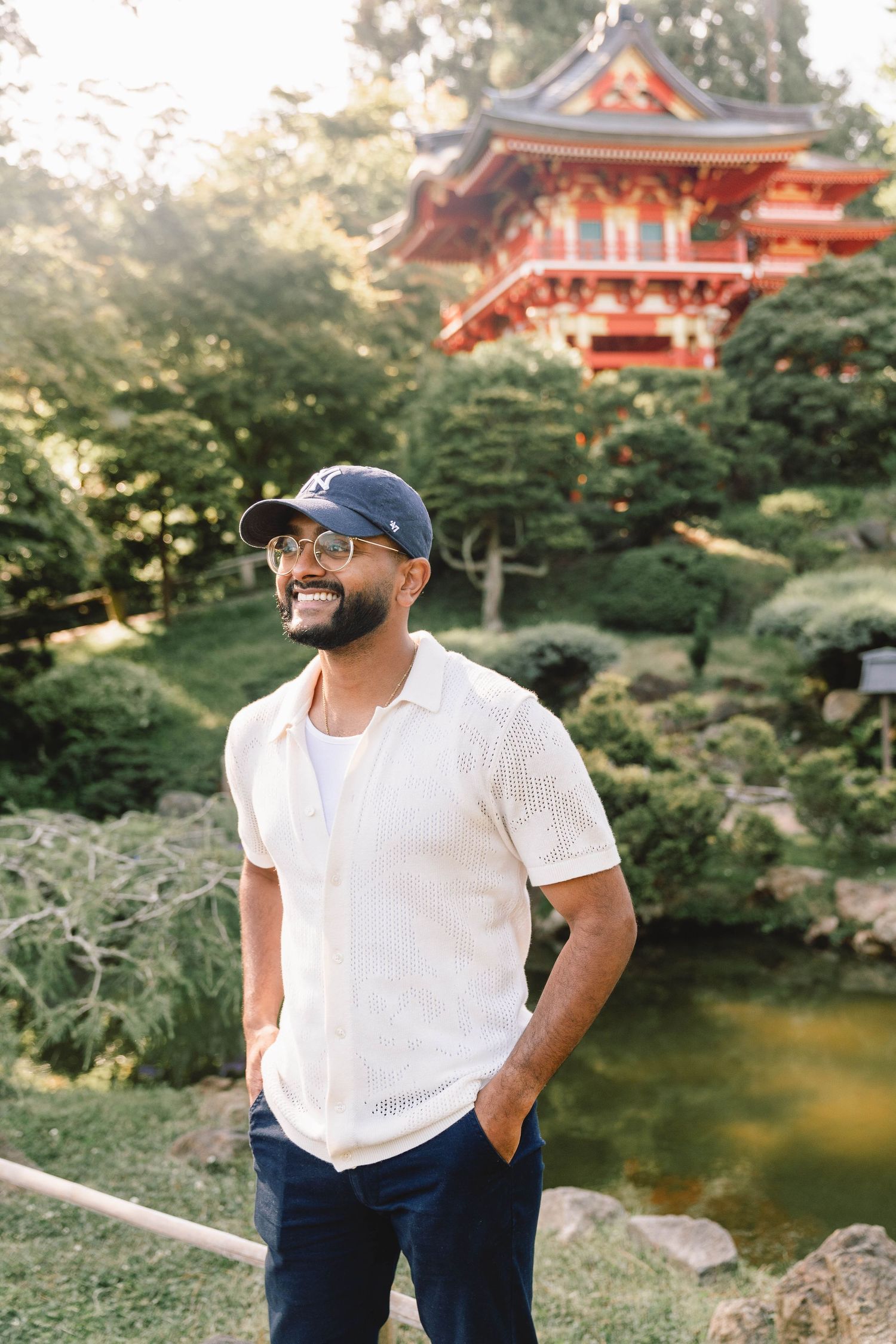 Photographer poses in summer linens at pagoda in the Japanese Tea Garden in San Francisco California