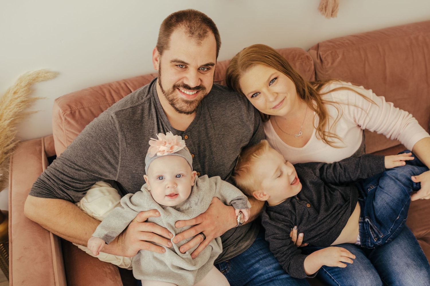 Family of four snuggled up on the couch
