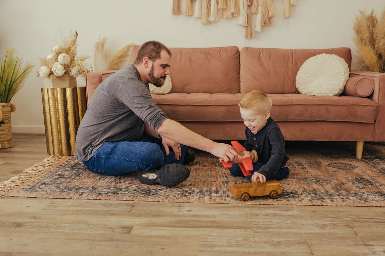dad and son playing with cars at a studio in Grand Prairie