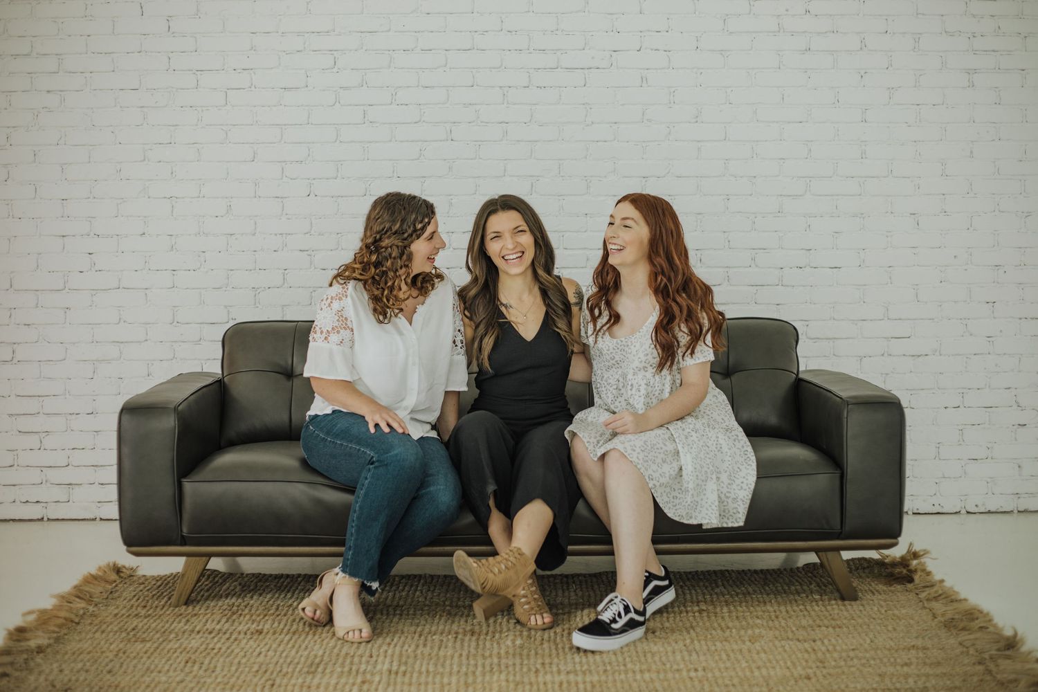 Adult sisters laughing on the couch