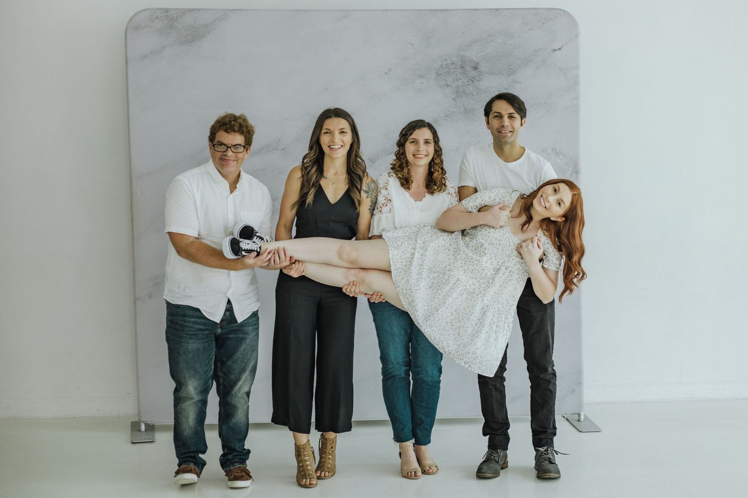 Fun adult sibling photo holding the youngest