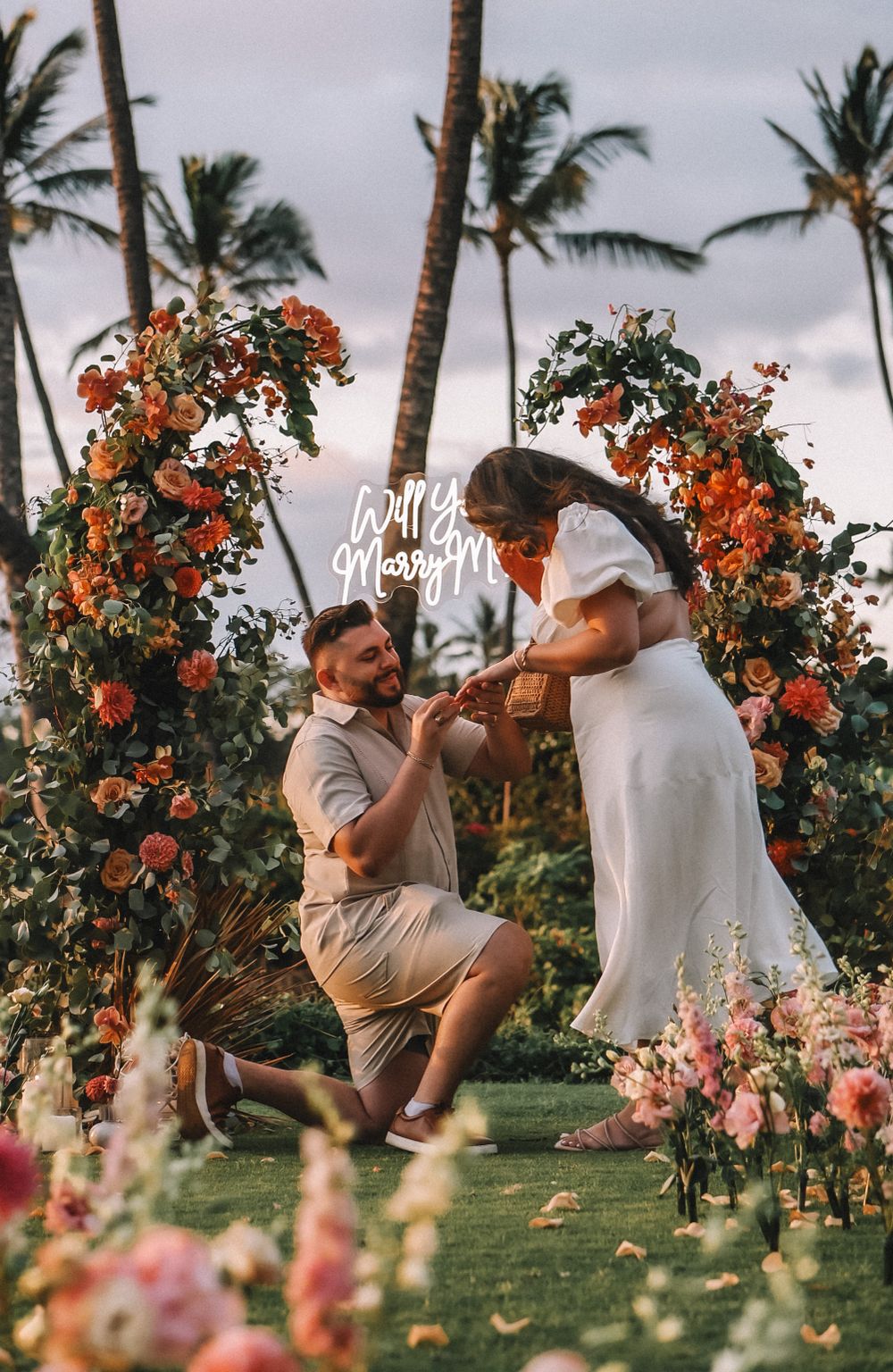Sunset wedding photo sequence with tropical flowers and swaying palm trees.