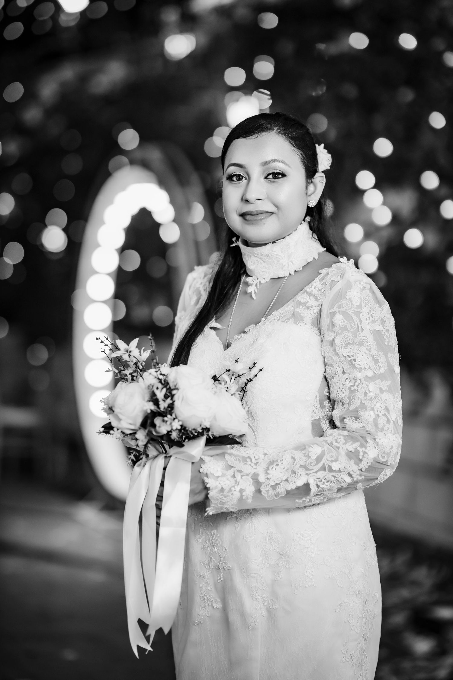 Black and white bridal portraits with sparkly bokeh lighting effects.