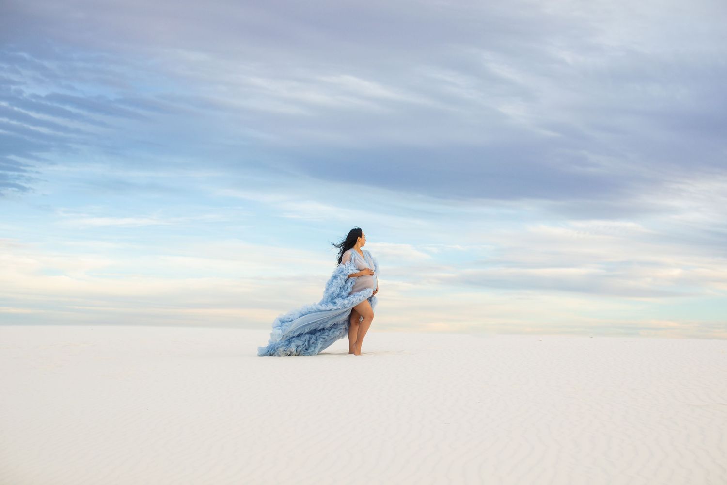 Stylish portrait of a woman in a flowing dress at White Sands, captured by a Tucson photographer.
