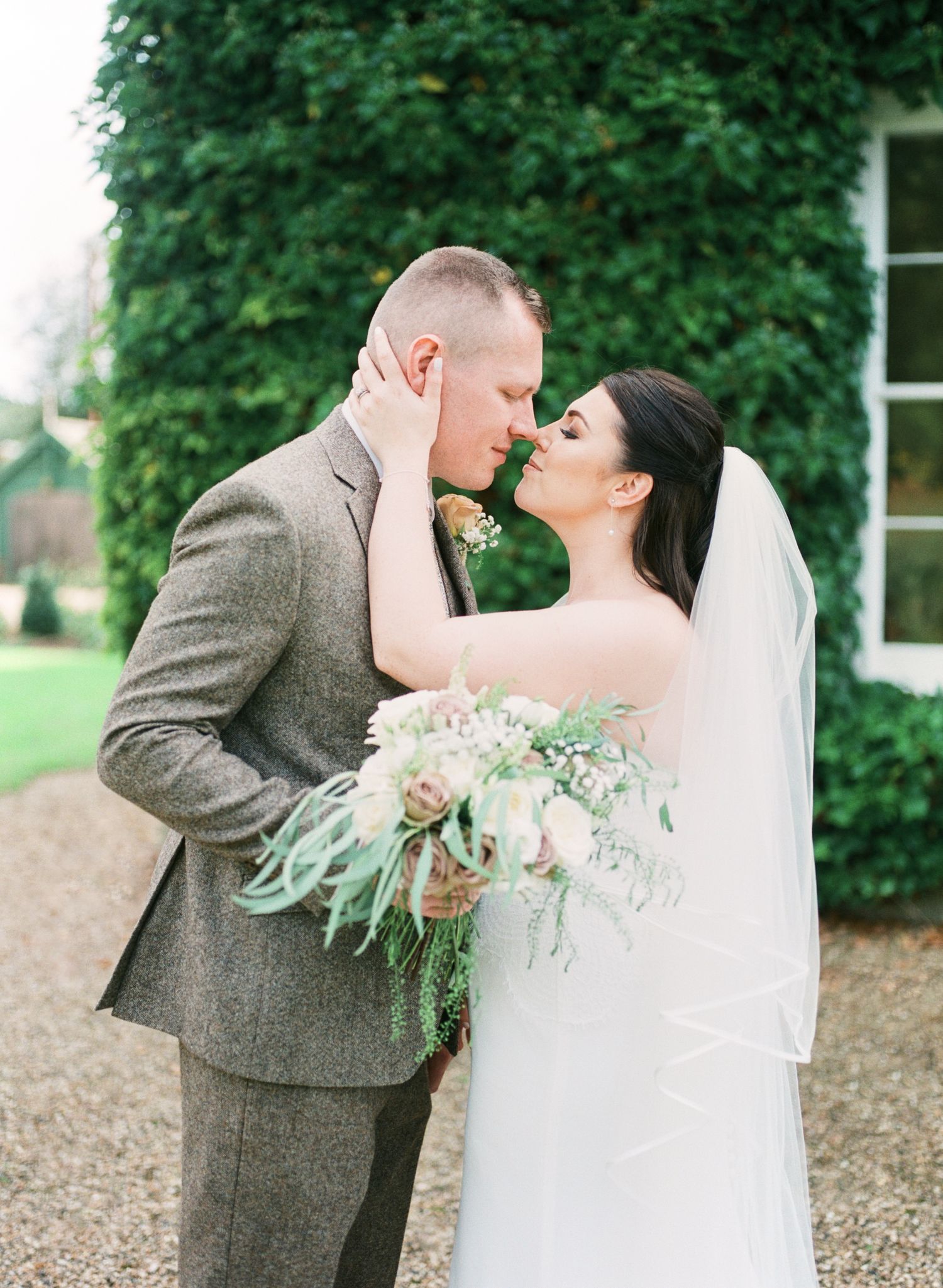 beautiful portrait of bride & groom in the gardens of Bressingham Hall, Norfork. by Faye Amare photography on film