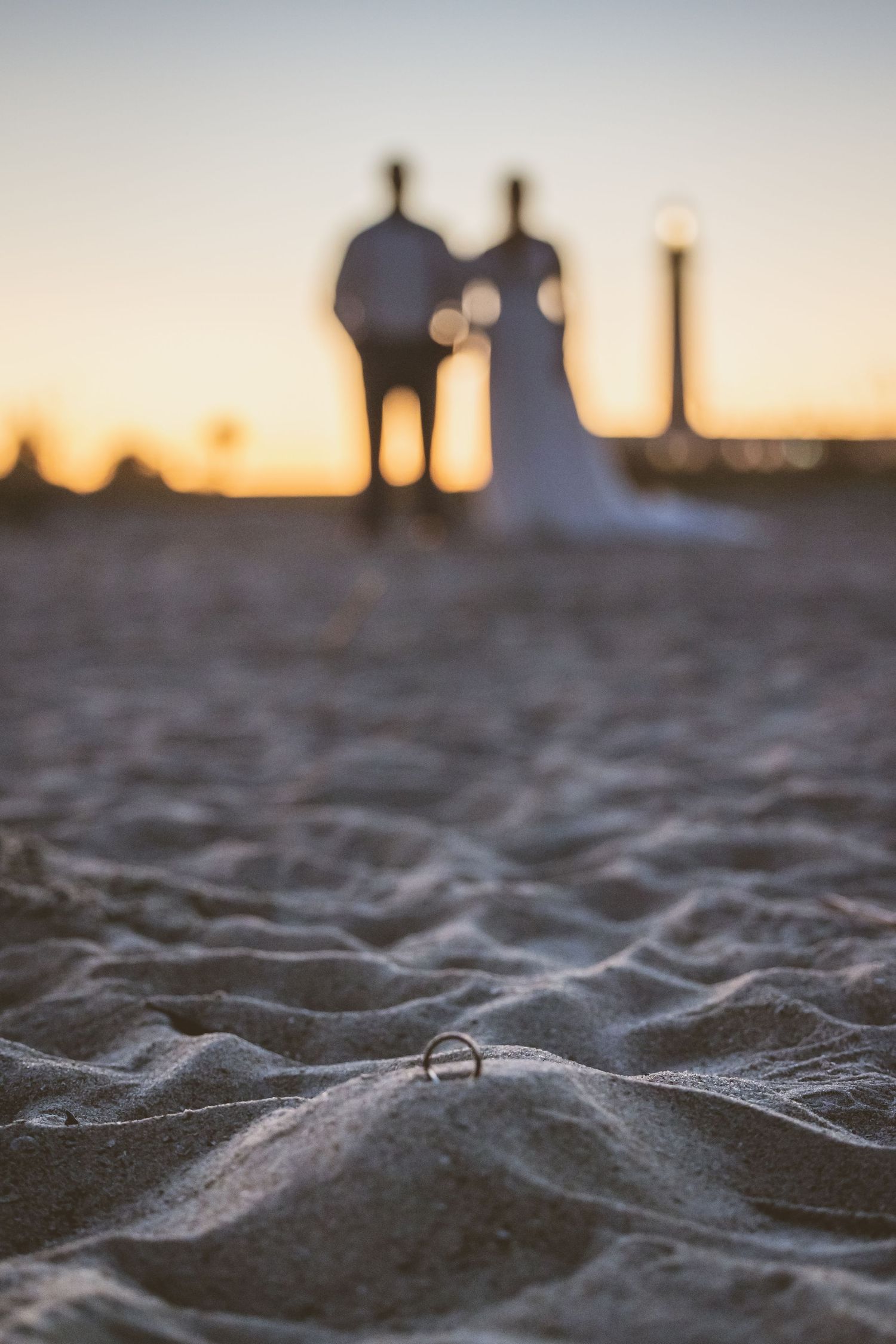 A unique ring photograph on the beach with the bride and groom on Tybee Island Ga.