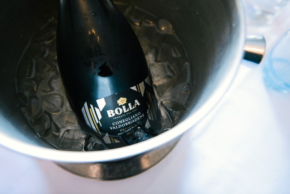 A bottle of champagne chilling in an ice bucket.