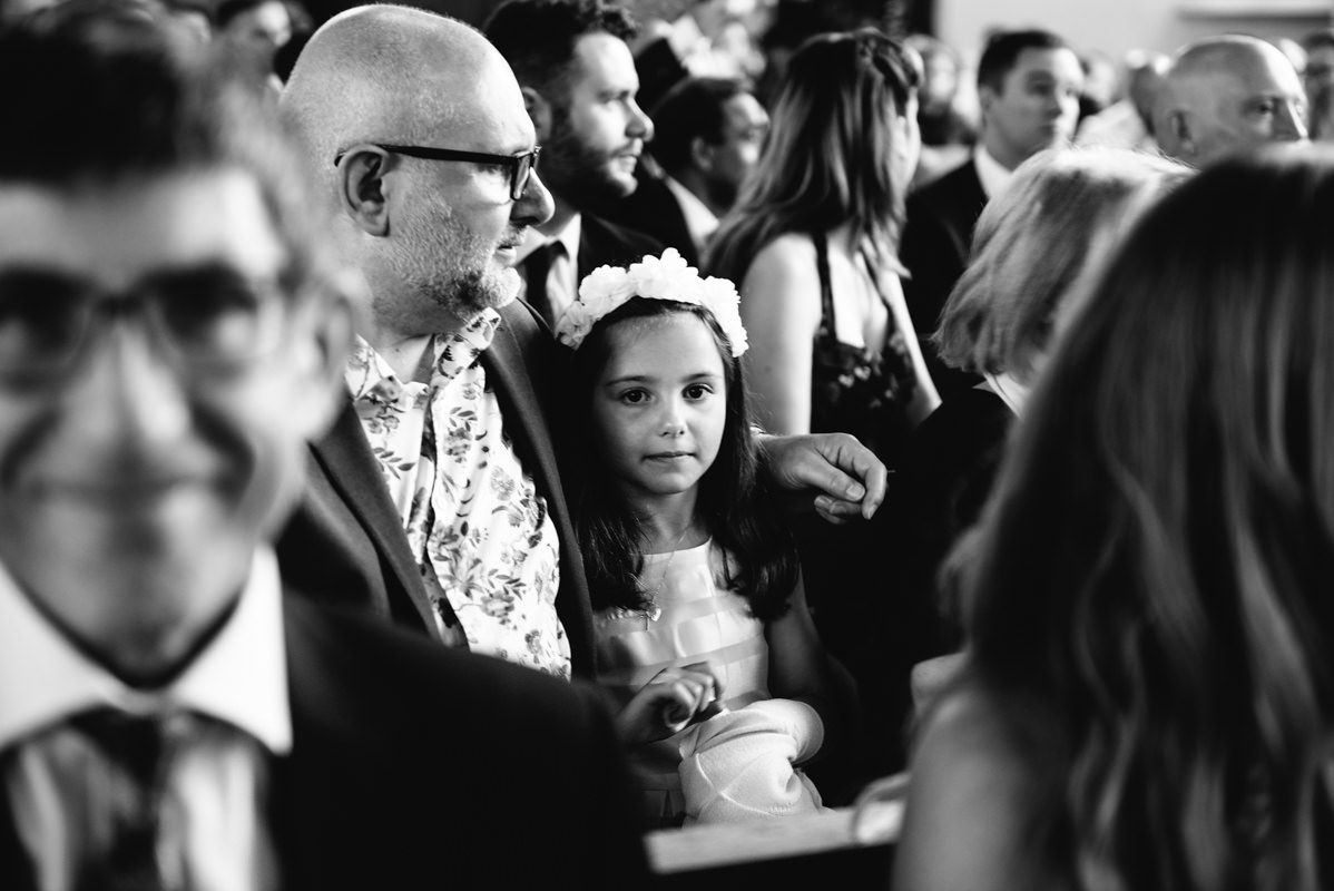 Black and white candid shot of guests during a church event.
