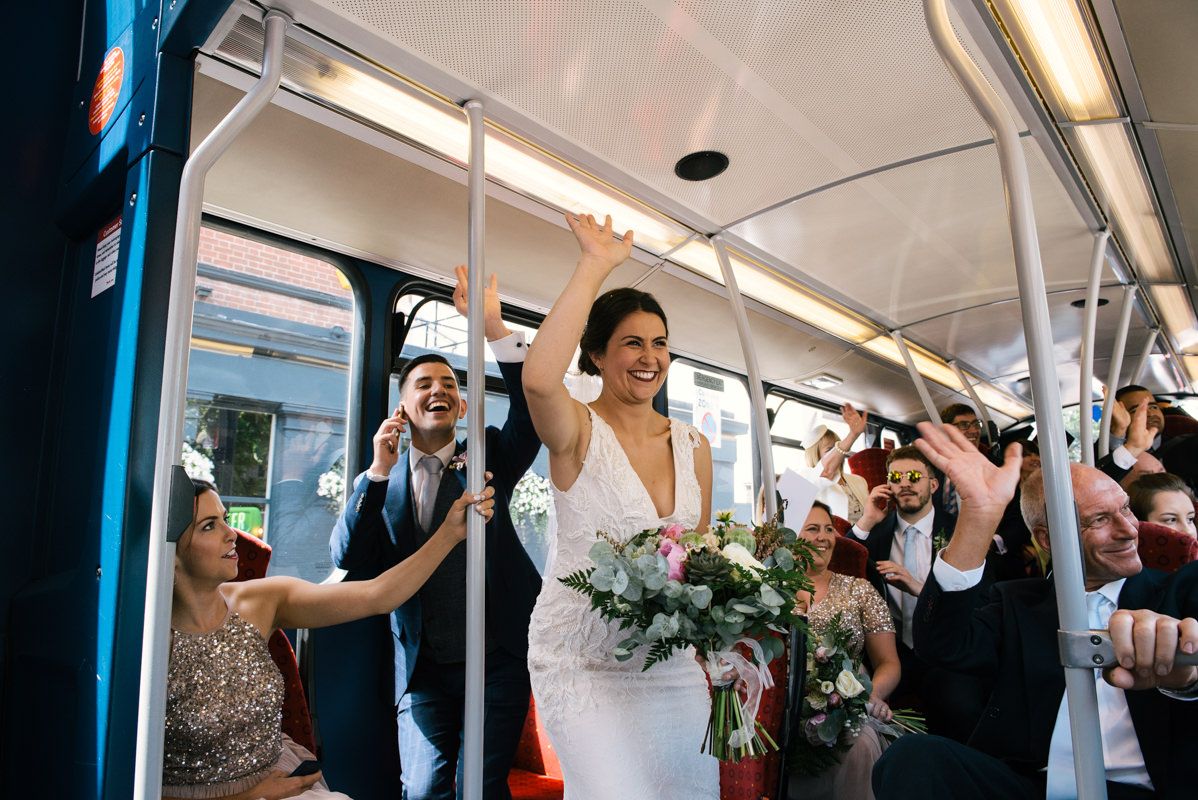 Wedding celebration continues on public transport as party rides city bus.