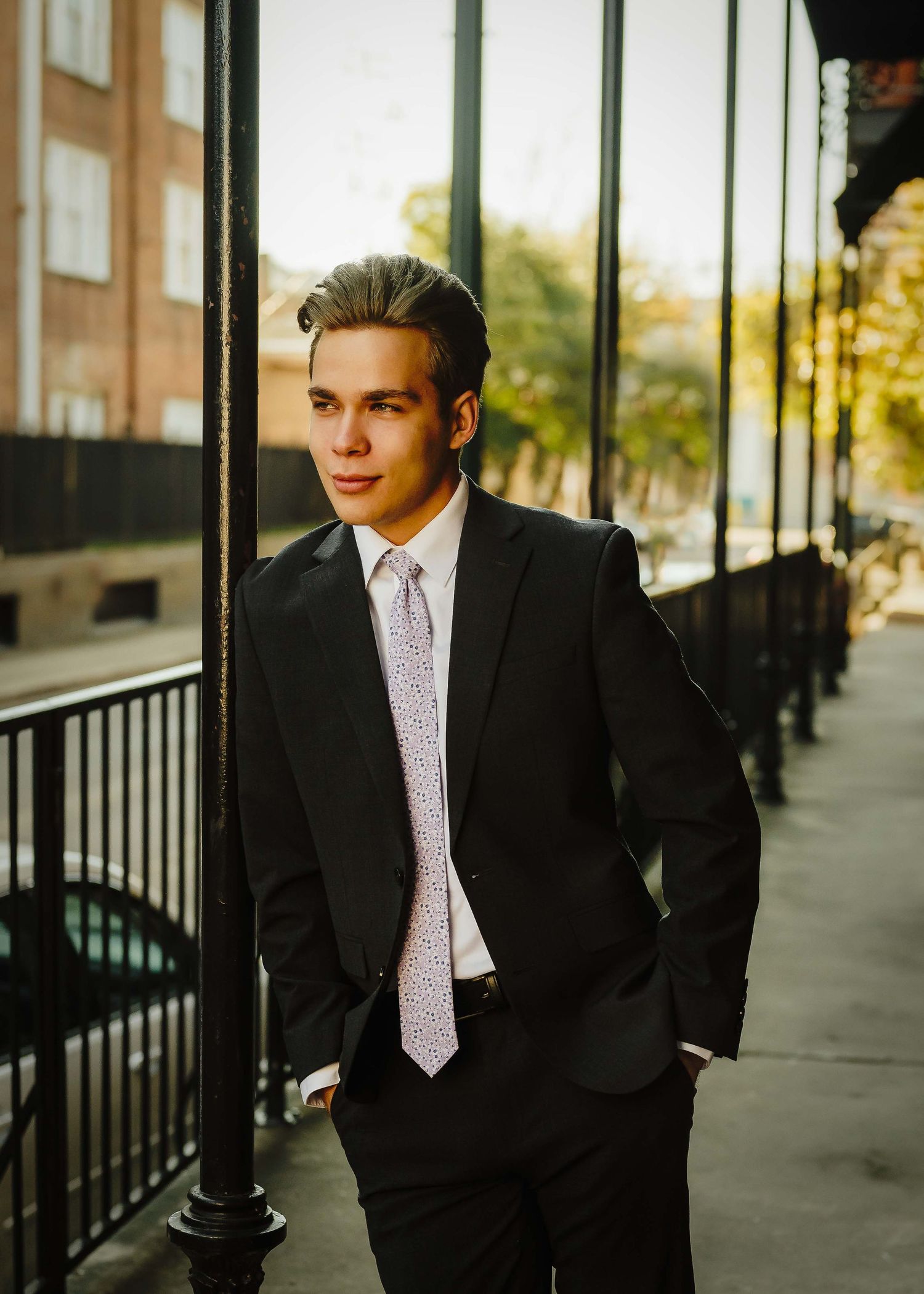 man gazing at a urban street wearing a suite and tie in downtown houston