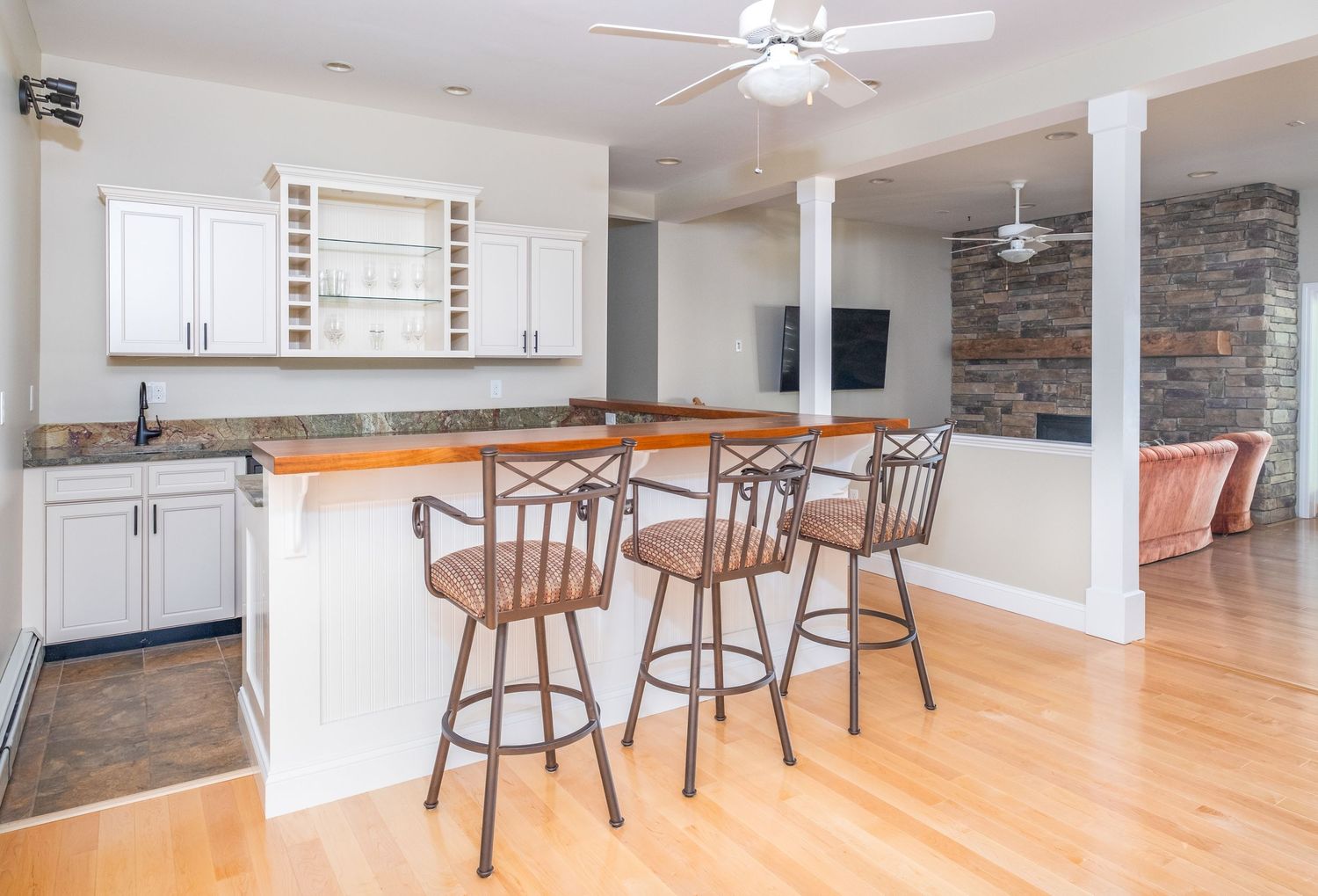 Basement bar area with walk out door at vacation rental property in Harrison, Maine.