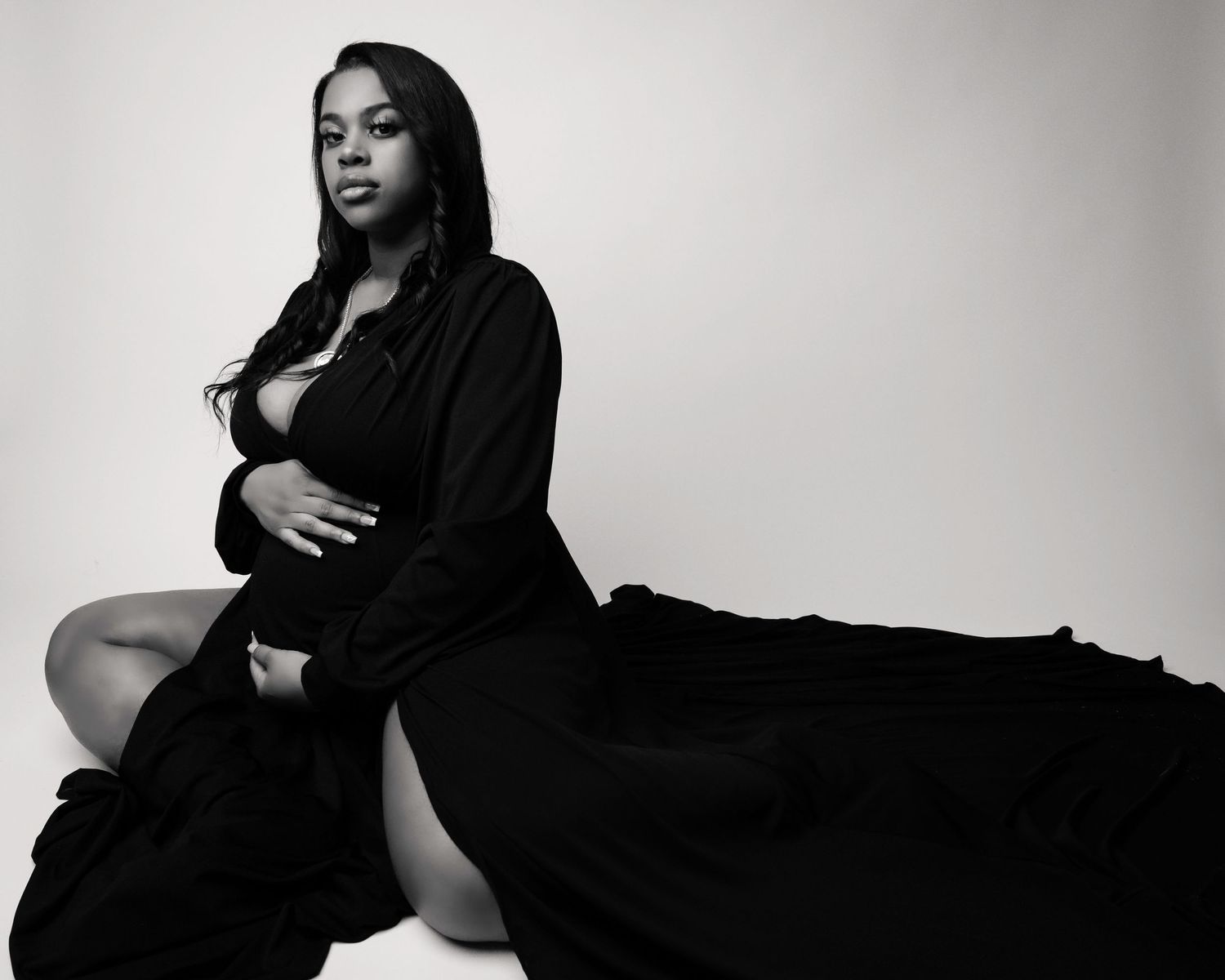 Black and white maternity portrait series with dramatic lighting.