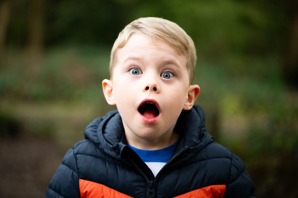 Litlte boy looking super surprised during a walk with his mummy, Ashtead.