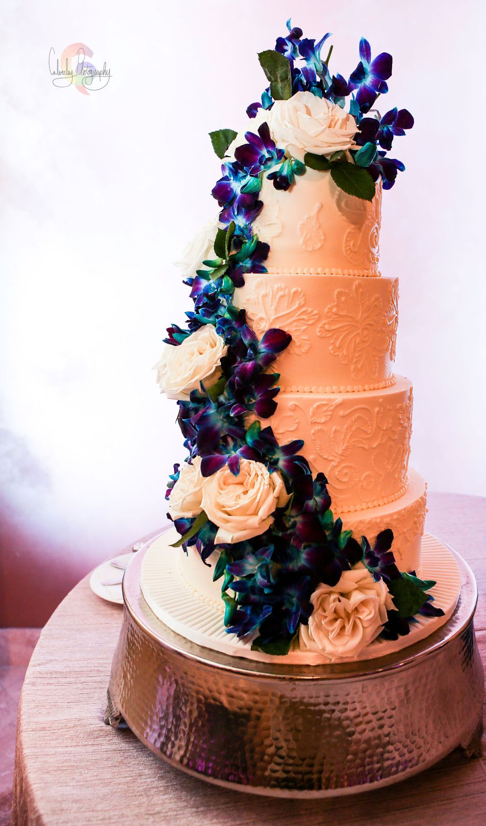 4 Tier Wedding Cake With Blue and White Flowers Bell Tower on 34th
