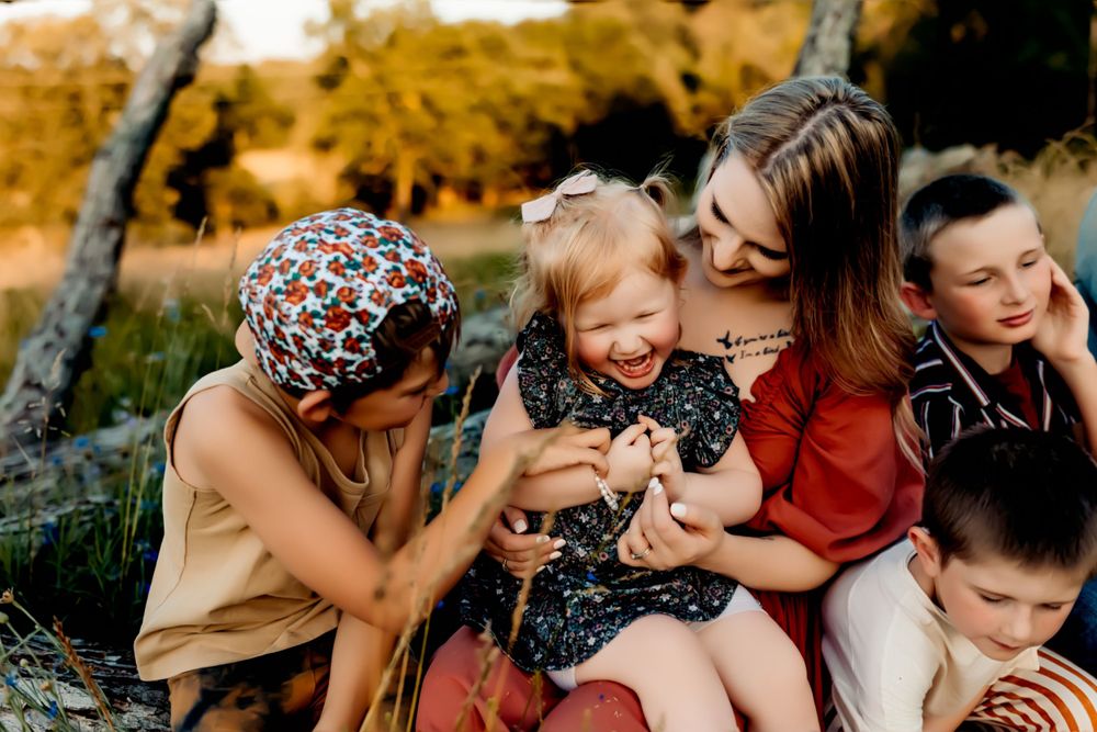 A candid outdoor family moment filled with laughter and joy.