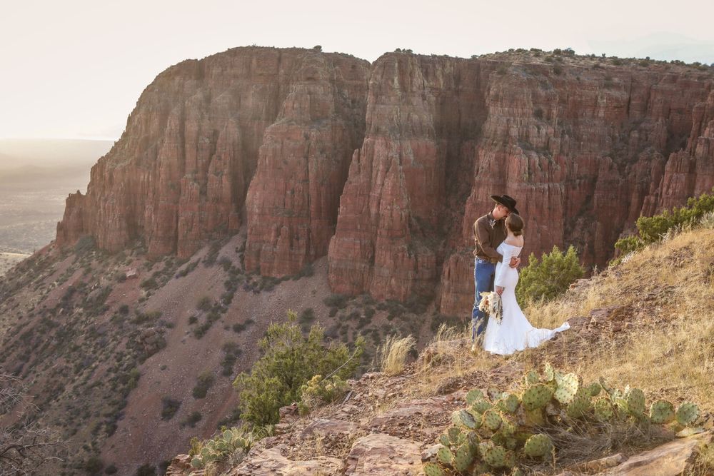 Scenic portrait of a bride and groom on a mountainside