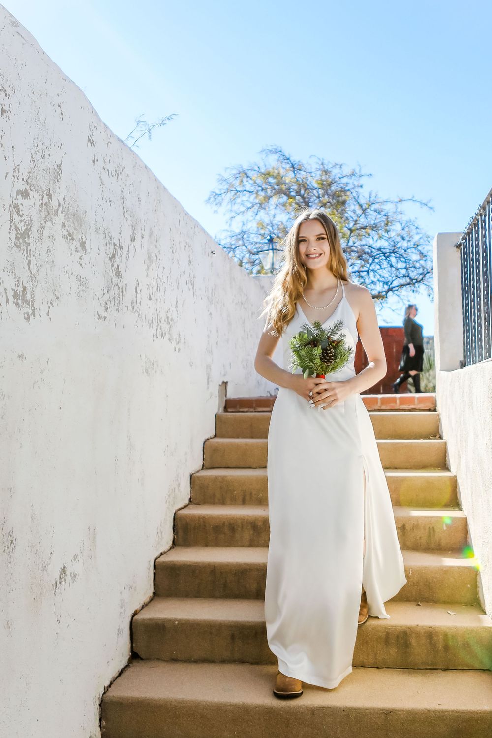 Portrait of a bride walking down the stair aisle