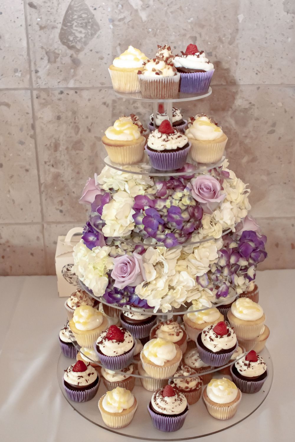 Picture of a wedding cupcake stand adorned with flowers