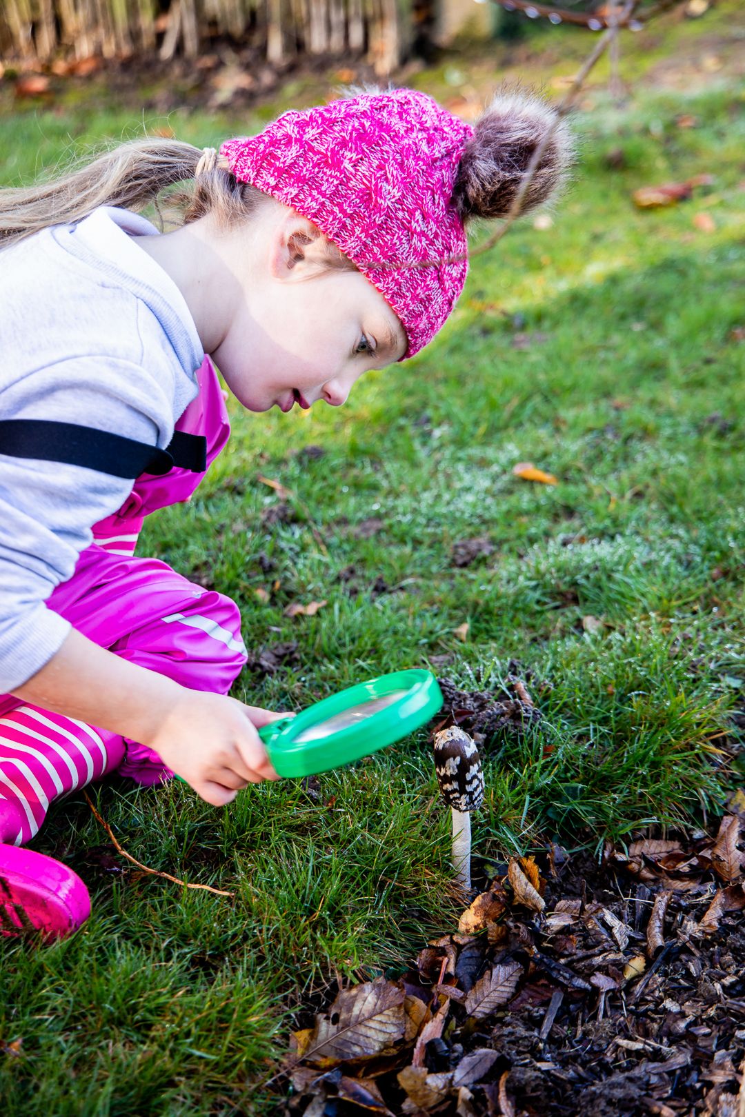 Little girl using a magnifying glass